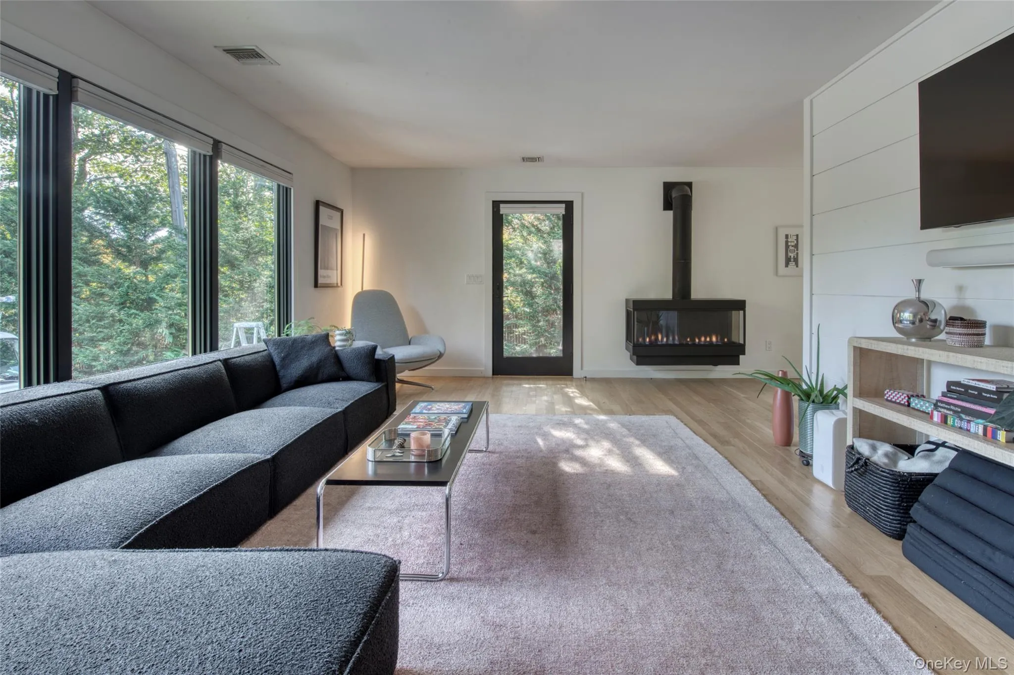 Living room with a wood stove and light wood-style floors Living room with a wood stove and light wood-style floors
