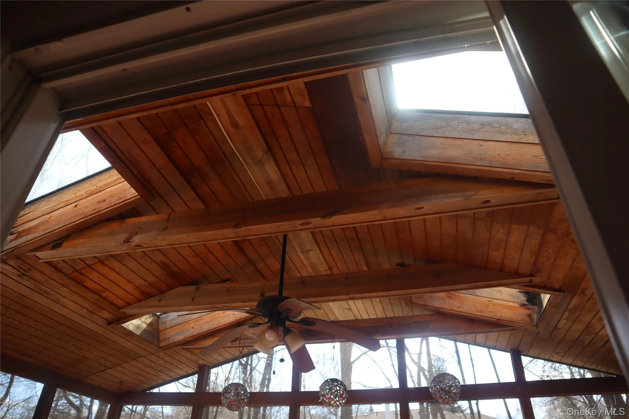 Detailed view of a ceiling fan and a skylight Detailed view of a ceiling fan and a skylight