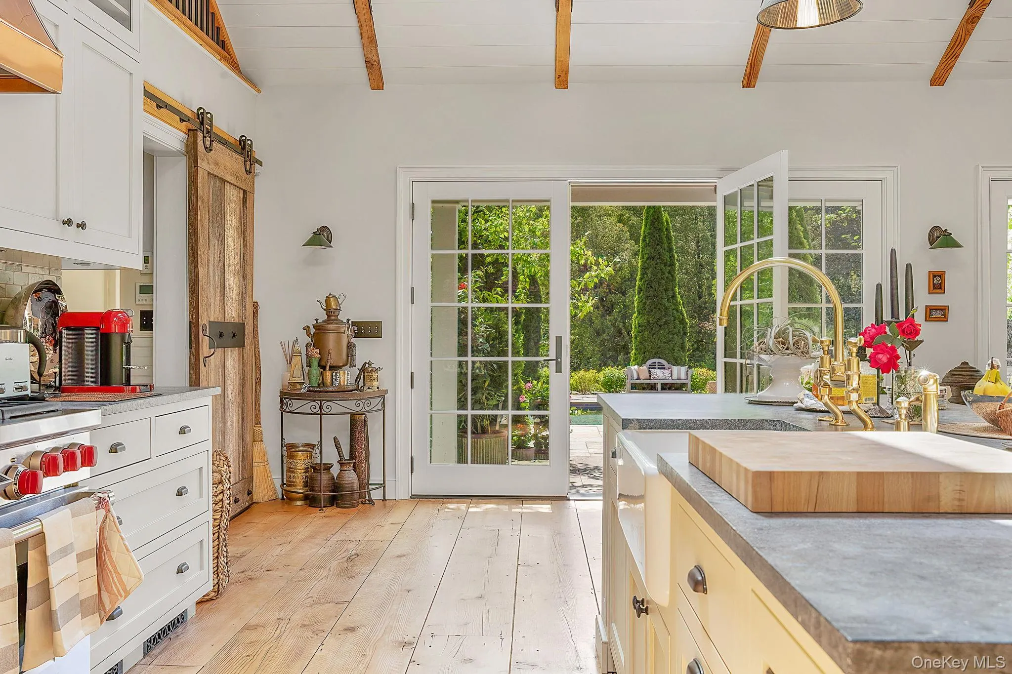 Doorway featuring a barn door, beamed ceiling, and hardwood / wood-style flooring Doorway featuring a barn door, beamed ceiling, and hardwood / wood-style flooring