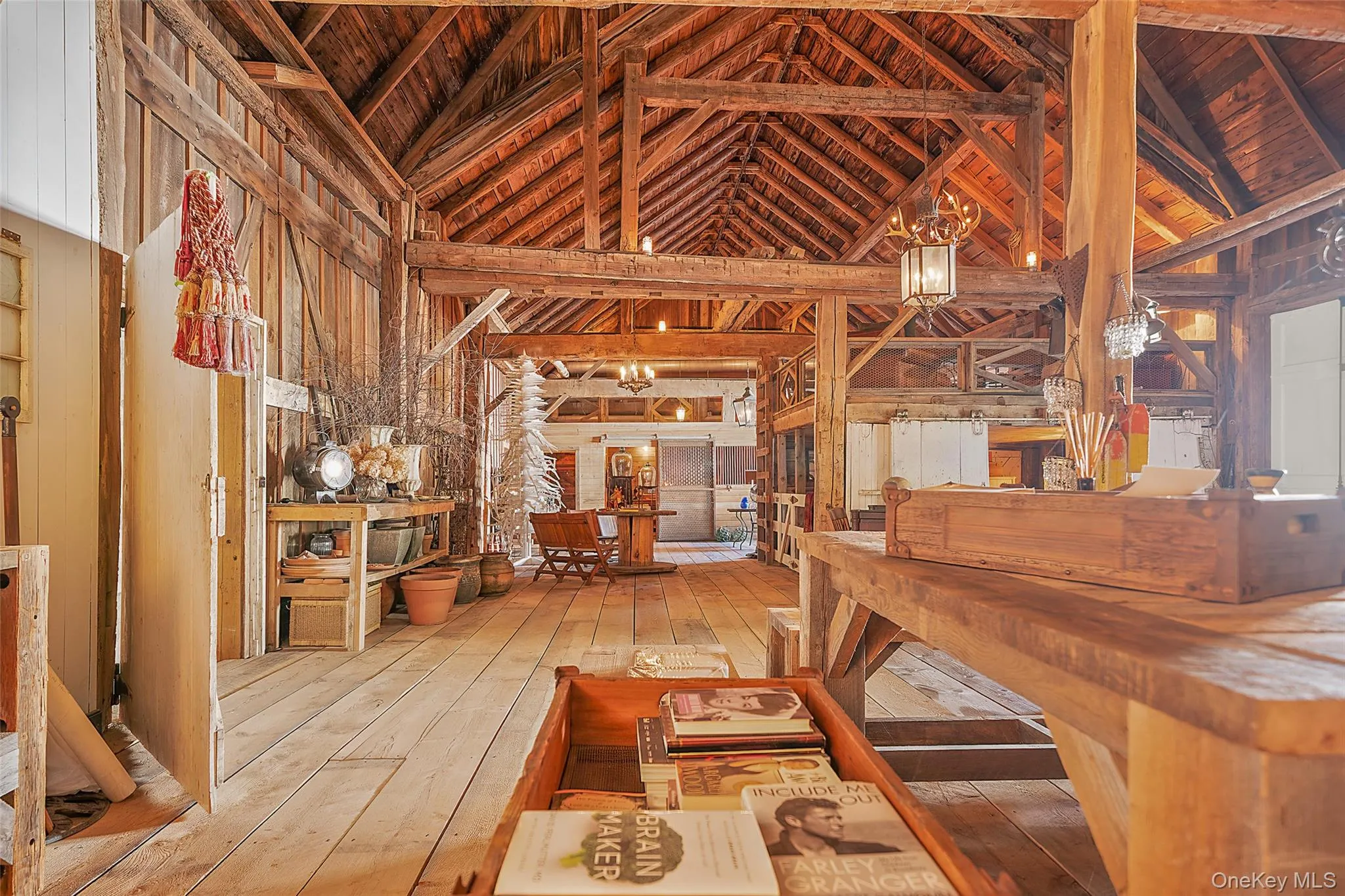 Miscellaneous room featuring wooden walls, high vaulted ceiling, hardwood / wood-style floors, and a wood ceiling with exposed beams Miscellaneous room featuring wooden walls, high vaulted ceiling, hardwood / wood-style floors, and a wood ceiling with exposed beams