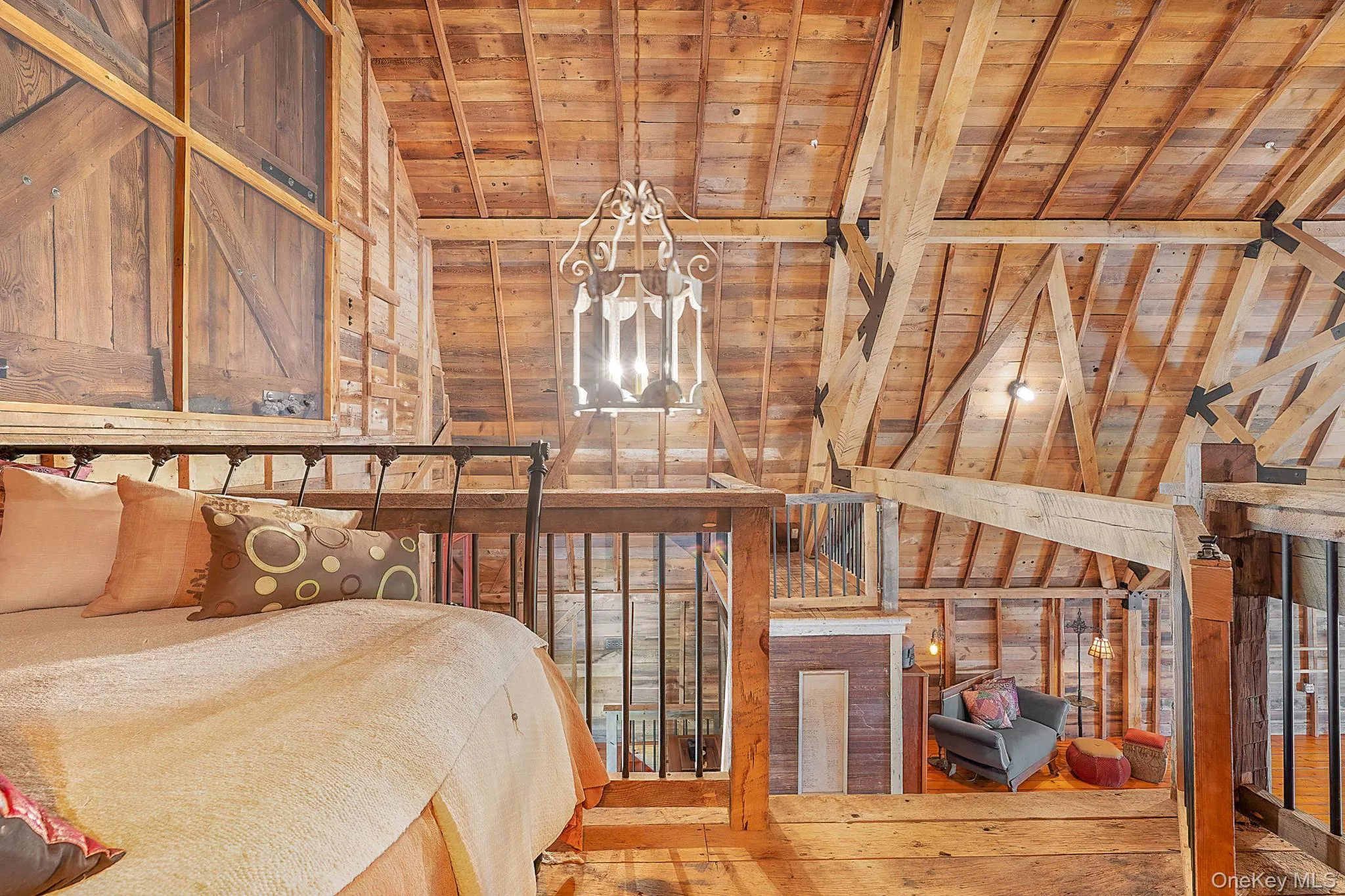 Bedroom featuring wood walls and a wood ceiling with exposed beams Bedroom featuring wood walls and a wood ceiling with exposed beams