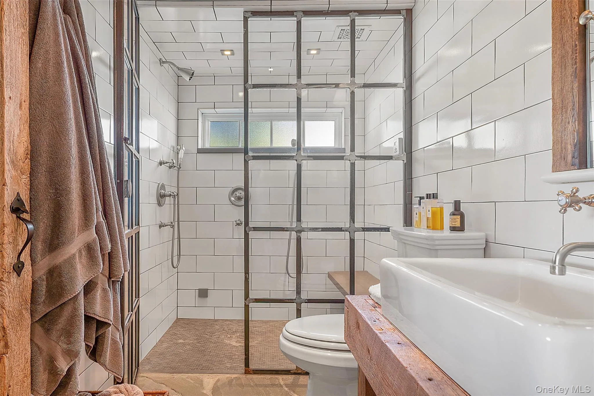 Full bath with a stall shower, vanity, and tile walls Full bath with a stall shower, vanity, and tile walls