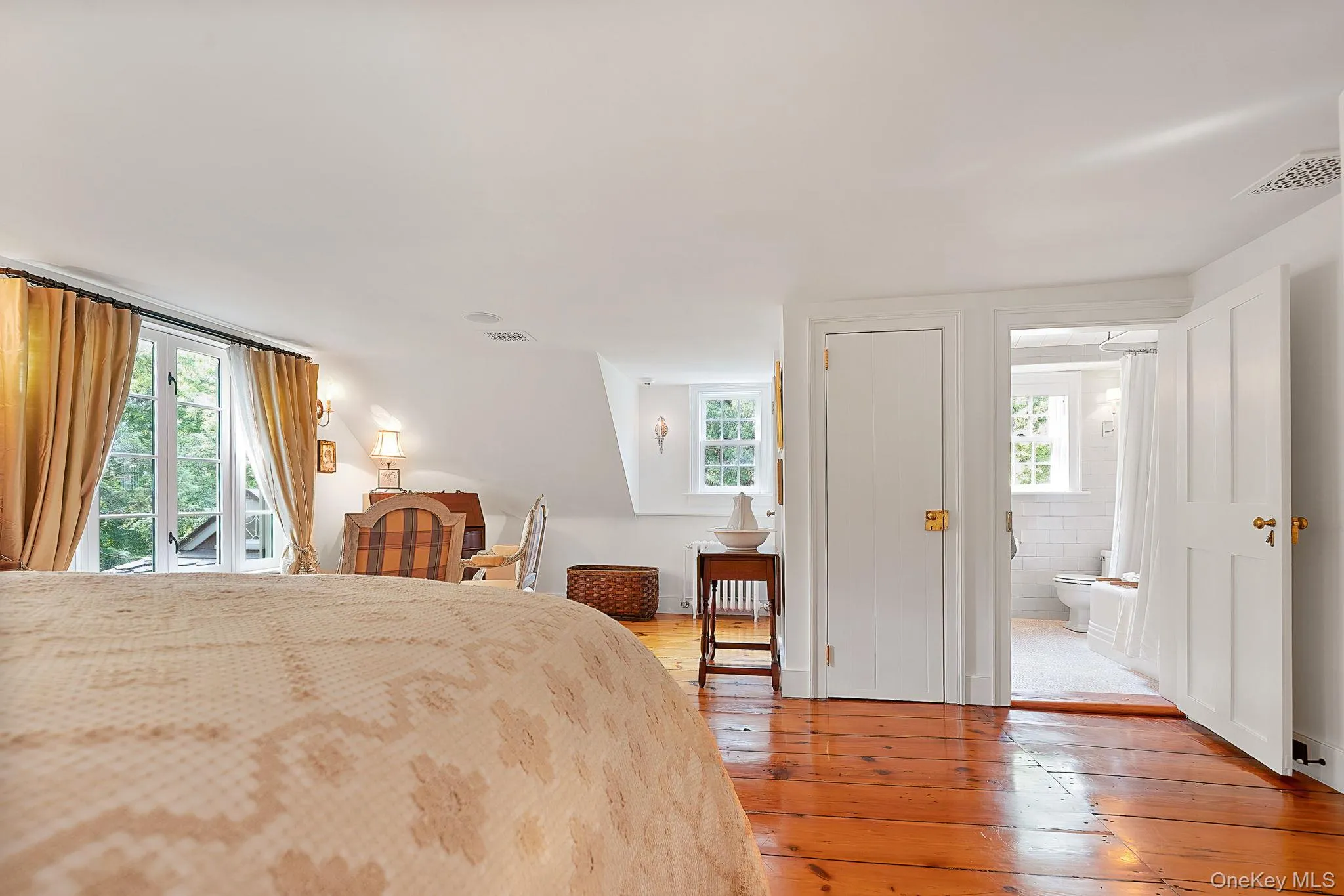 Bedroom with light wood-style floors, access to outside, and radiator Bedroom with light wood-style floors, access to outside, and radiator