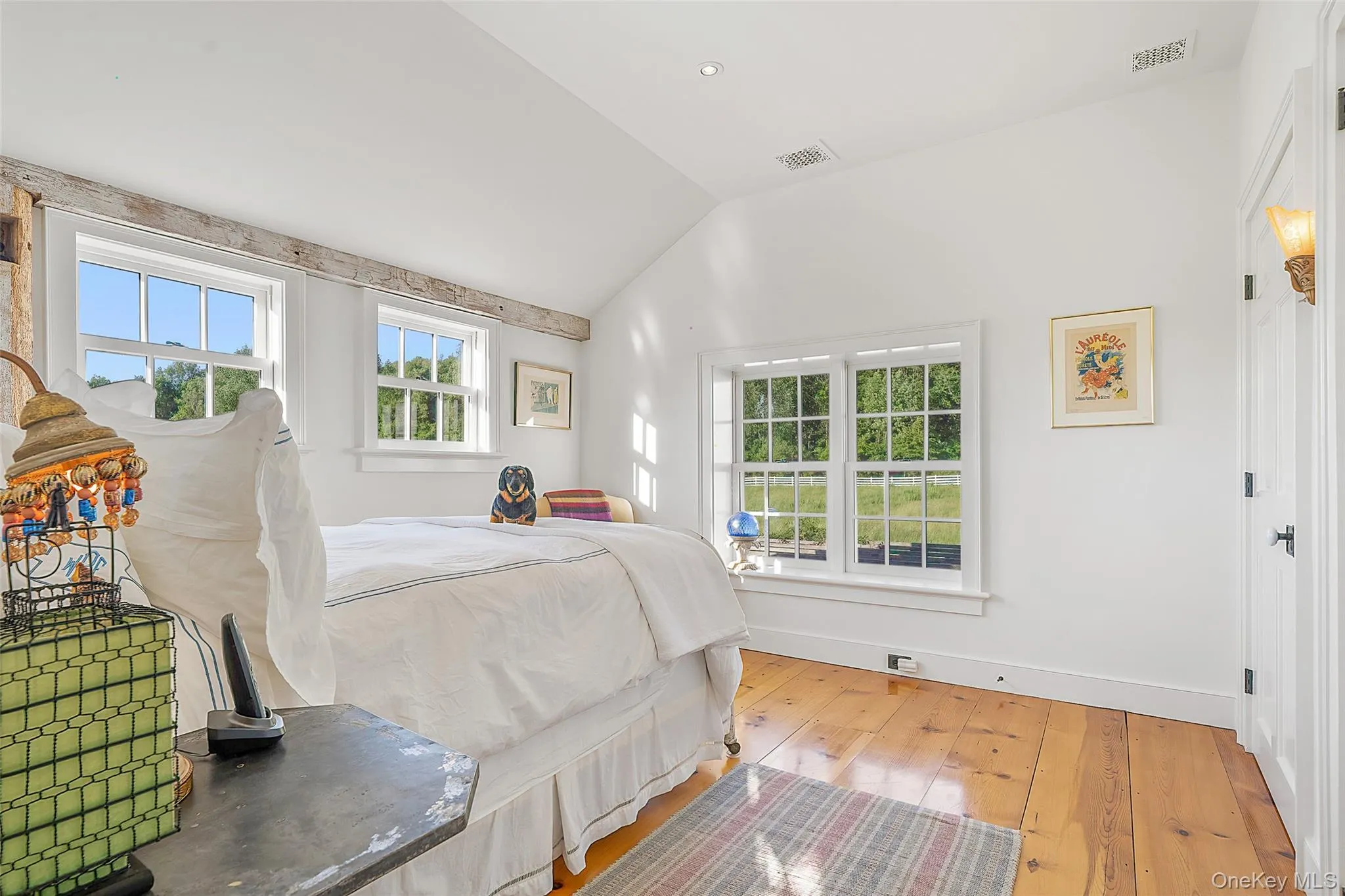 Bedroom featuring multiple windows, hardwood / wood-style flooring, lofted ceiling, and recessed lighting Bedroom featuring multiple windows, hardwood / wood-style flooring, lofted ceiling, and recessed lighting