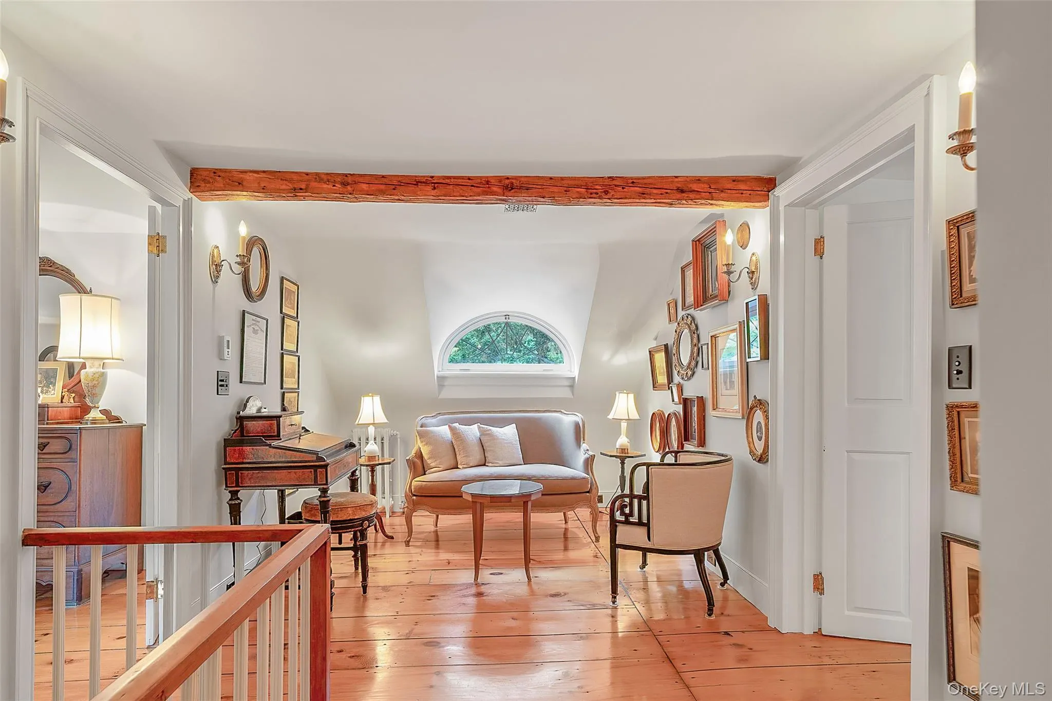 Living area with light wood-style flooring and beam ceiling Living area with light wood-style flooring and beam ceiling