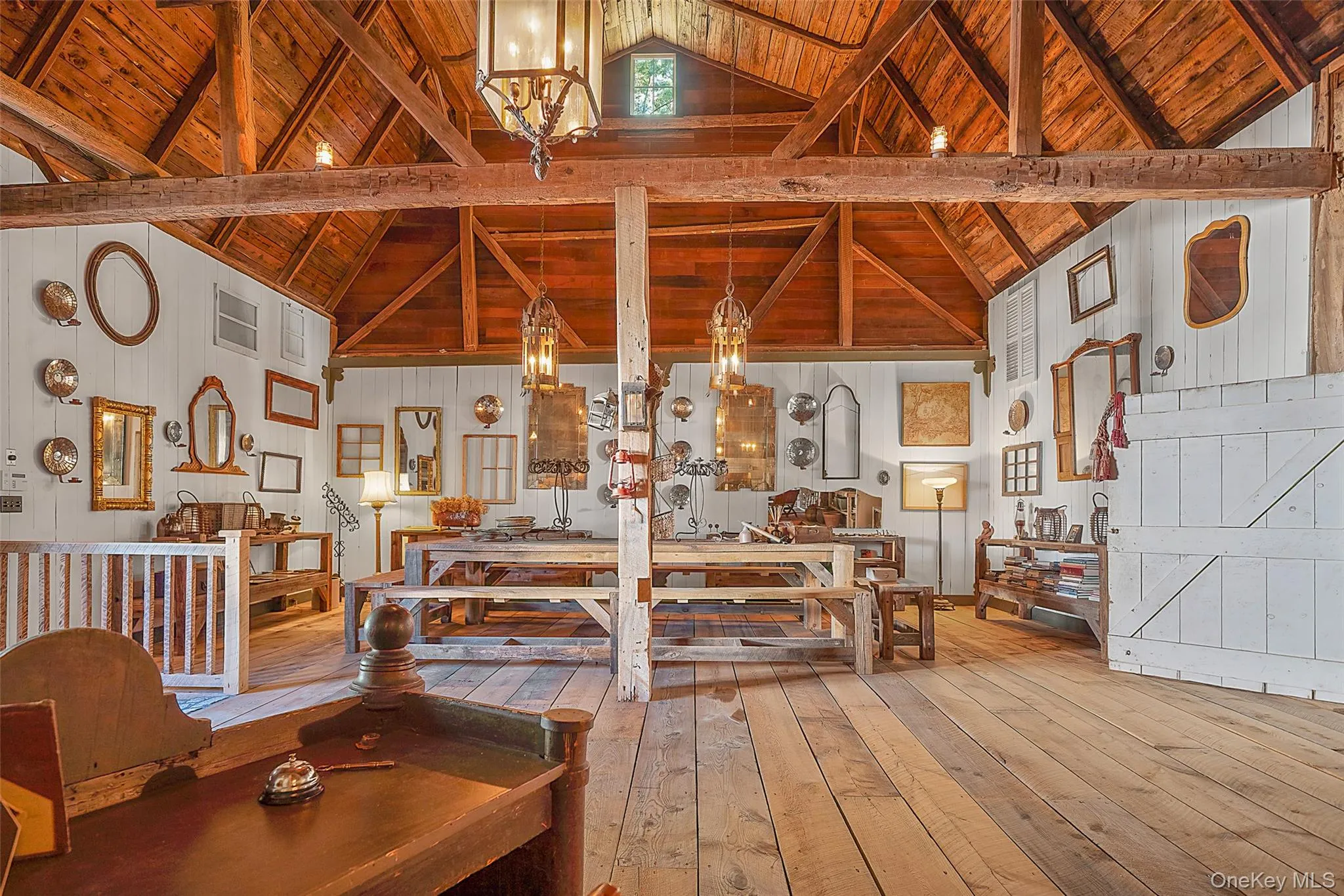Dining space with a wood ceiling with exposed beams, a chandelier, hardwood / wood-style floors, wooden walls, and high vaulted ceiling Dining space with a wood ceiling with exposed beams, a chandelier, hardwood / wood-style floors, wooden walls, and high vaulted ceiling