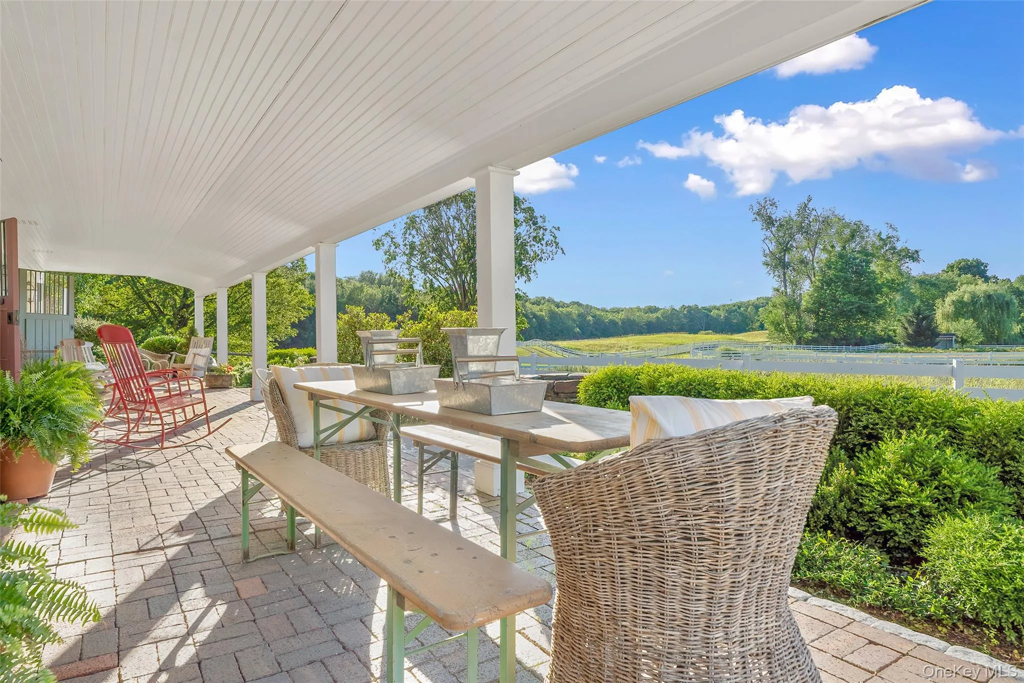 View of patio featuring outdoor dining space and view of wooded area View of patio featuring outdoor dining space and view of wooded area
