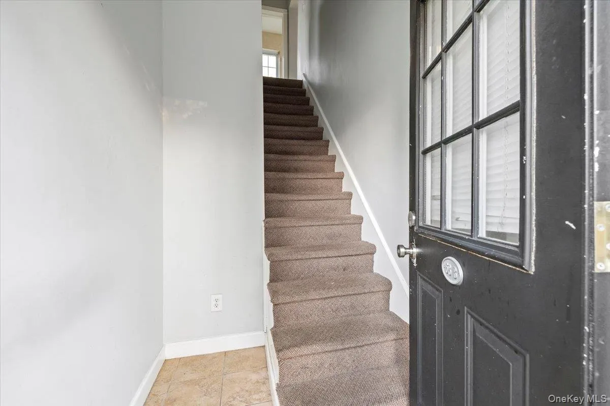 Stairs with baseboards and tile patterned flooring Stairs with baseboards and tile patterned flooring