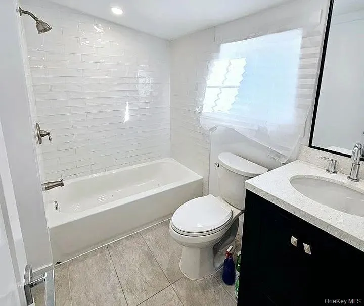 Bathroom featuring vanity and washtub / shower combination Bathroom featuring vanity and washtub / shower combination