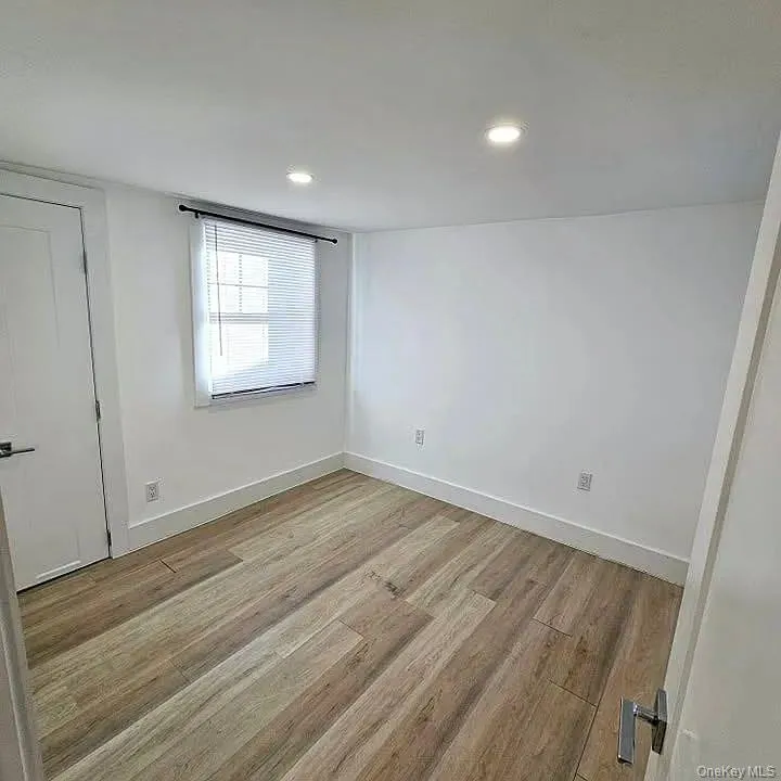 Empty room with light wood-style floors and recessed lighting Empty room with light wood-style floors and recessed lighting