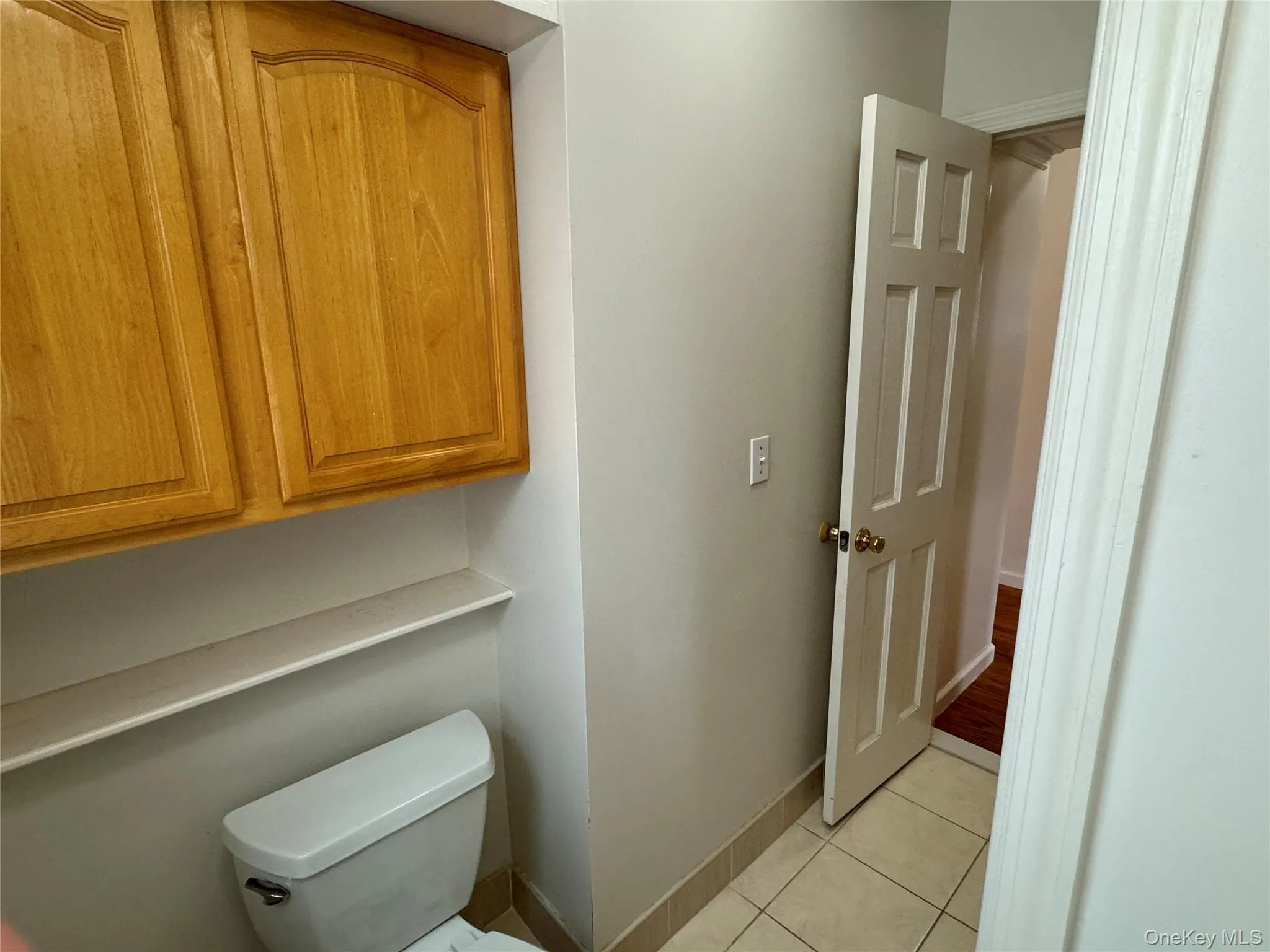 Half bathroom with light tile patterned floors and baseboards Half bathroom with light tile patterned floors and baseboards