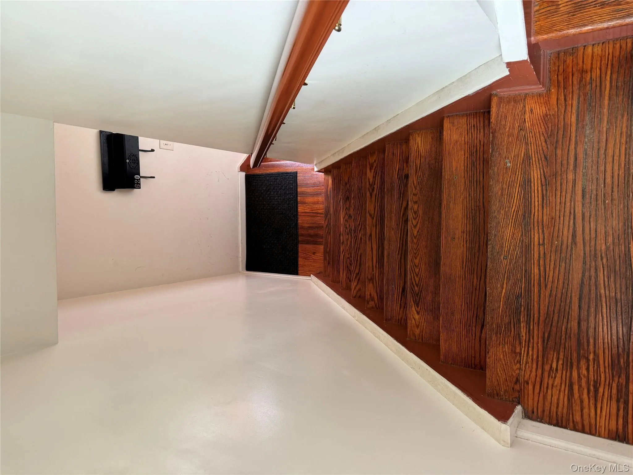 Stairs featuring wood finished floors and baseboards Stairs featuring wood finished floors and baseboards