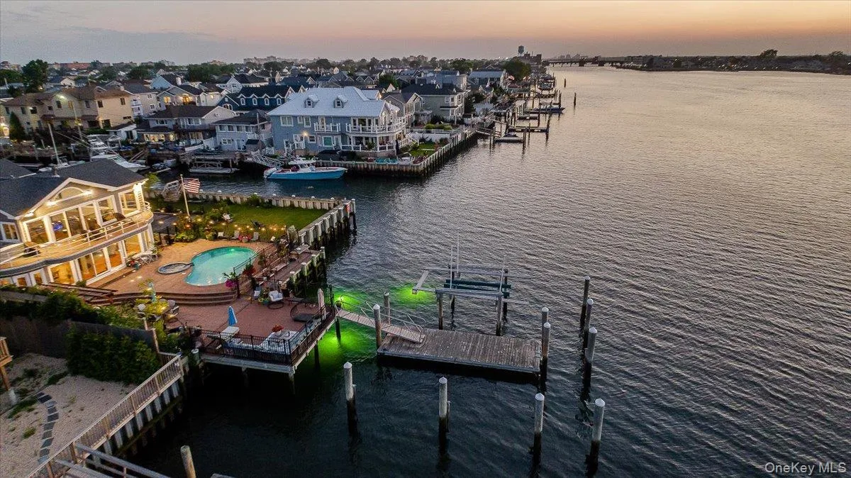 Aerial view of residential area featuring a nearby body of water Aerial view of residential area featuring a nearby body of water