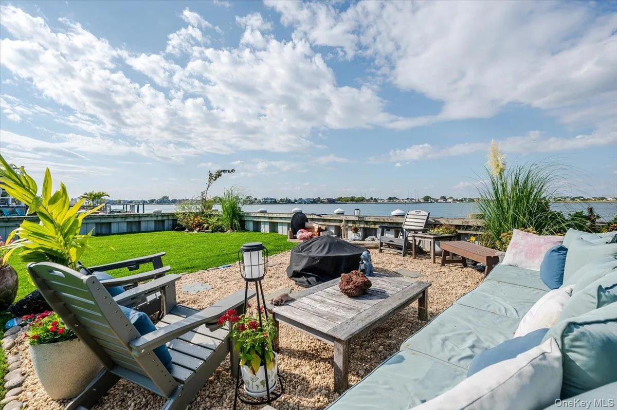 View of patio featuring a water view, a grill, and an outdoor living space with a fire pit View of patio featuring a water view, a grill, and an outdoor living space with a fire pit