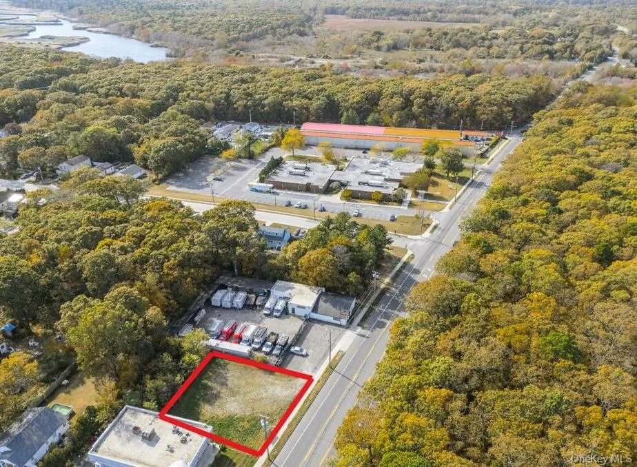 Aerial view of property and surrounding area featuring a large body of water and property boundaries highlighted Aerial view of property and surrounding area featuring a large body of water and property boundaries highlighted