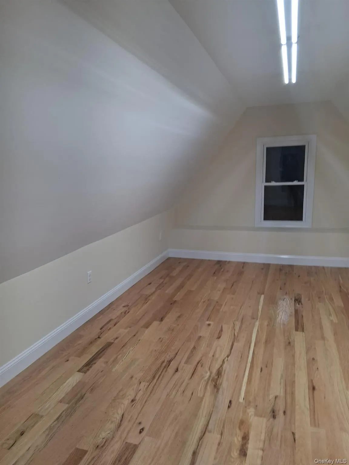 Bonus room featuring light wood-type flooring and vaulted ceiling Bonus room featuring light wood-type flooring and vaulted ceiling