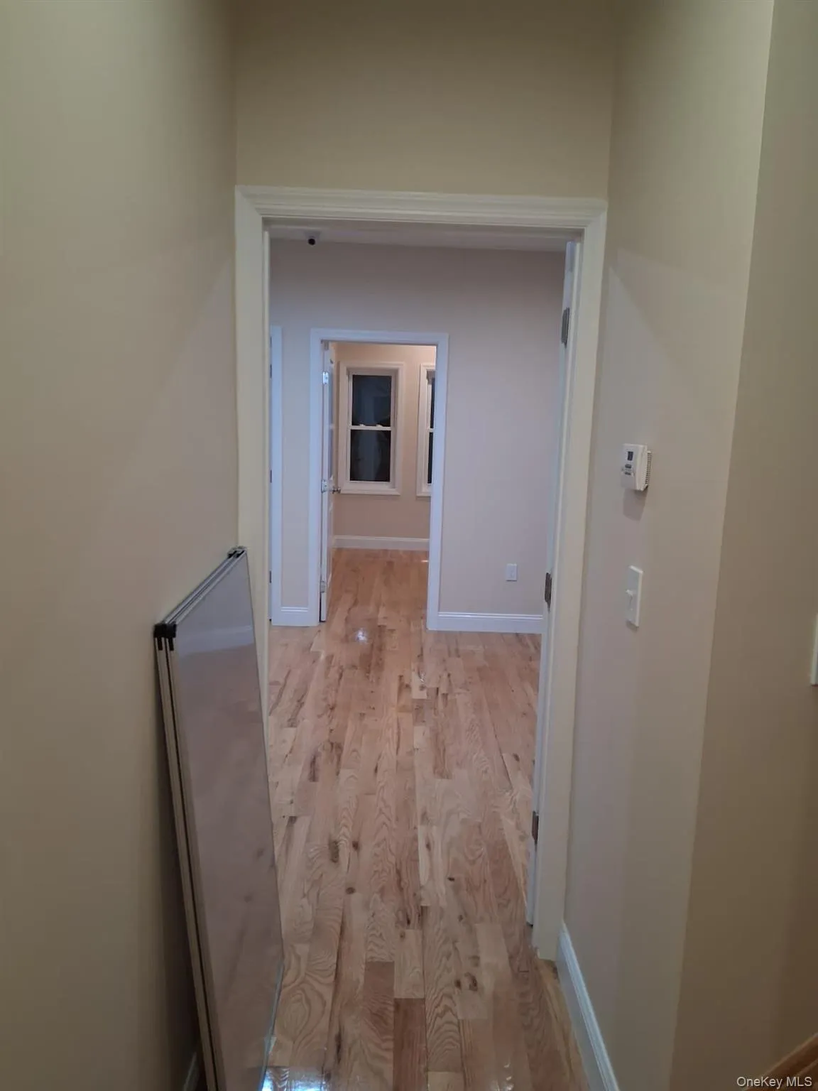 Hall with light wood-style floors and baseboards Hall with light wood-style floors and baseboards