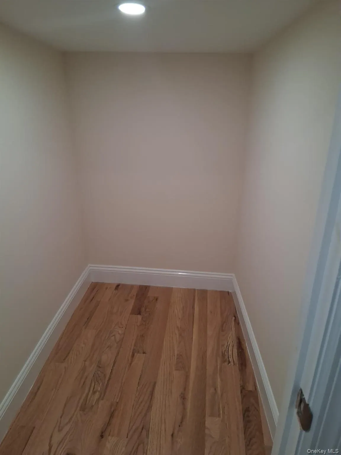 Empty room with wood finished floors and recessed lighting Empty room with wood finished floors and recessed lighting