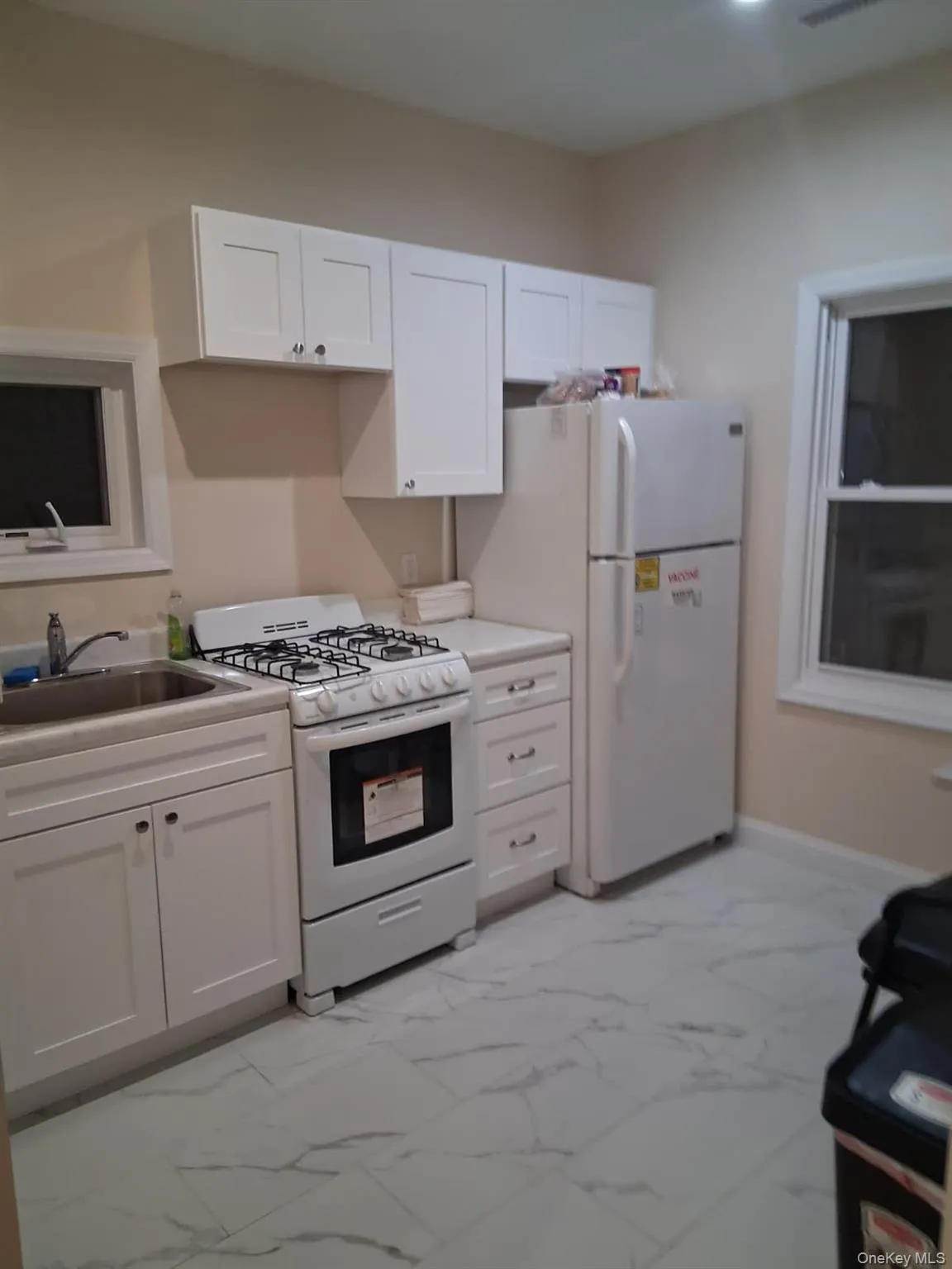 Kitchen with white cabinets and white appliances Kitchen with white cabinets and white appliances