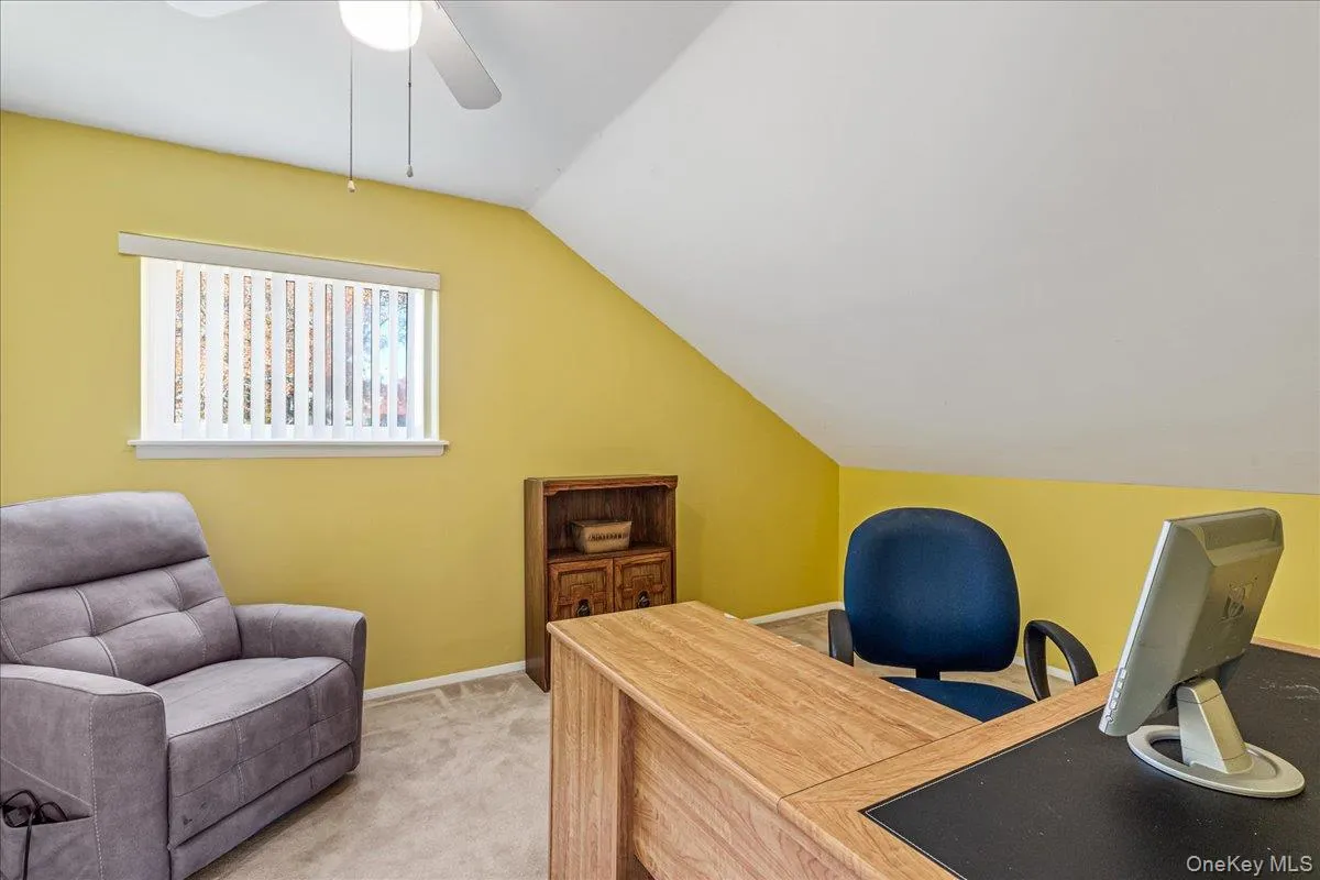 Office featuring lofted ceiling and light colored carpet Office featuring lofted ceiling and light colored carpet