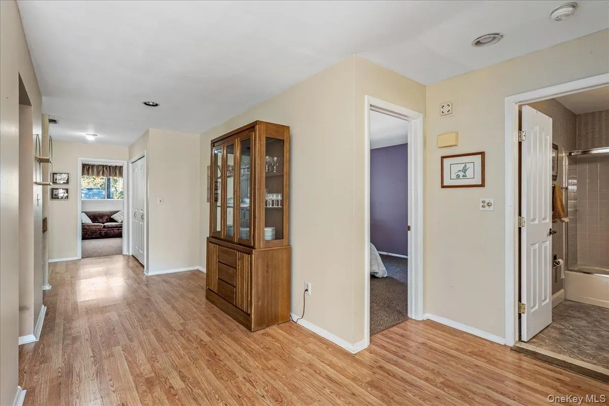 Corridor featuring light wood-style flooring Corridor featuring light wood-style flooring