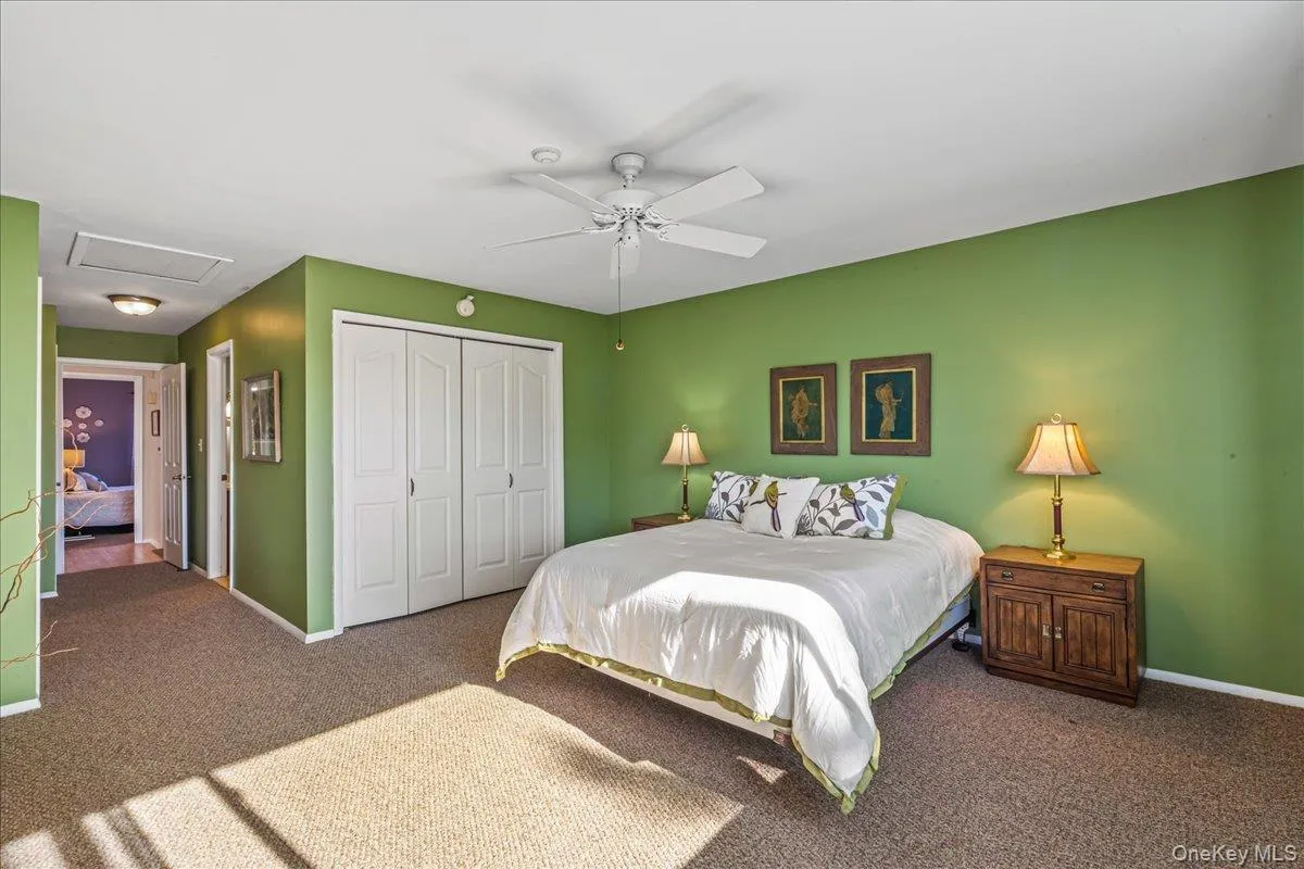 Bedroom featuring attic access, carpet, a closet, and a ceiling fan Bedroom featuring attic access, carpet, a closet, and a ceiling fan