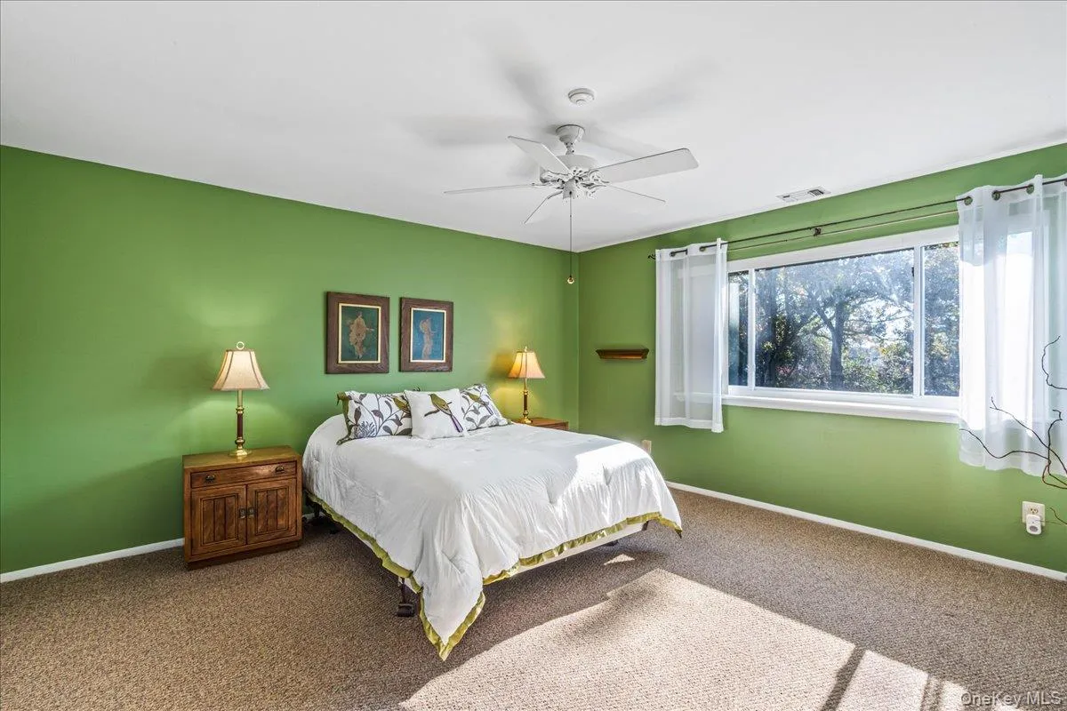Carpeted bedroom with baseboards and a ceiling fan Carpeted bedroom with baseboards and a ceiling fan