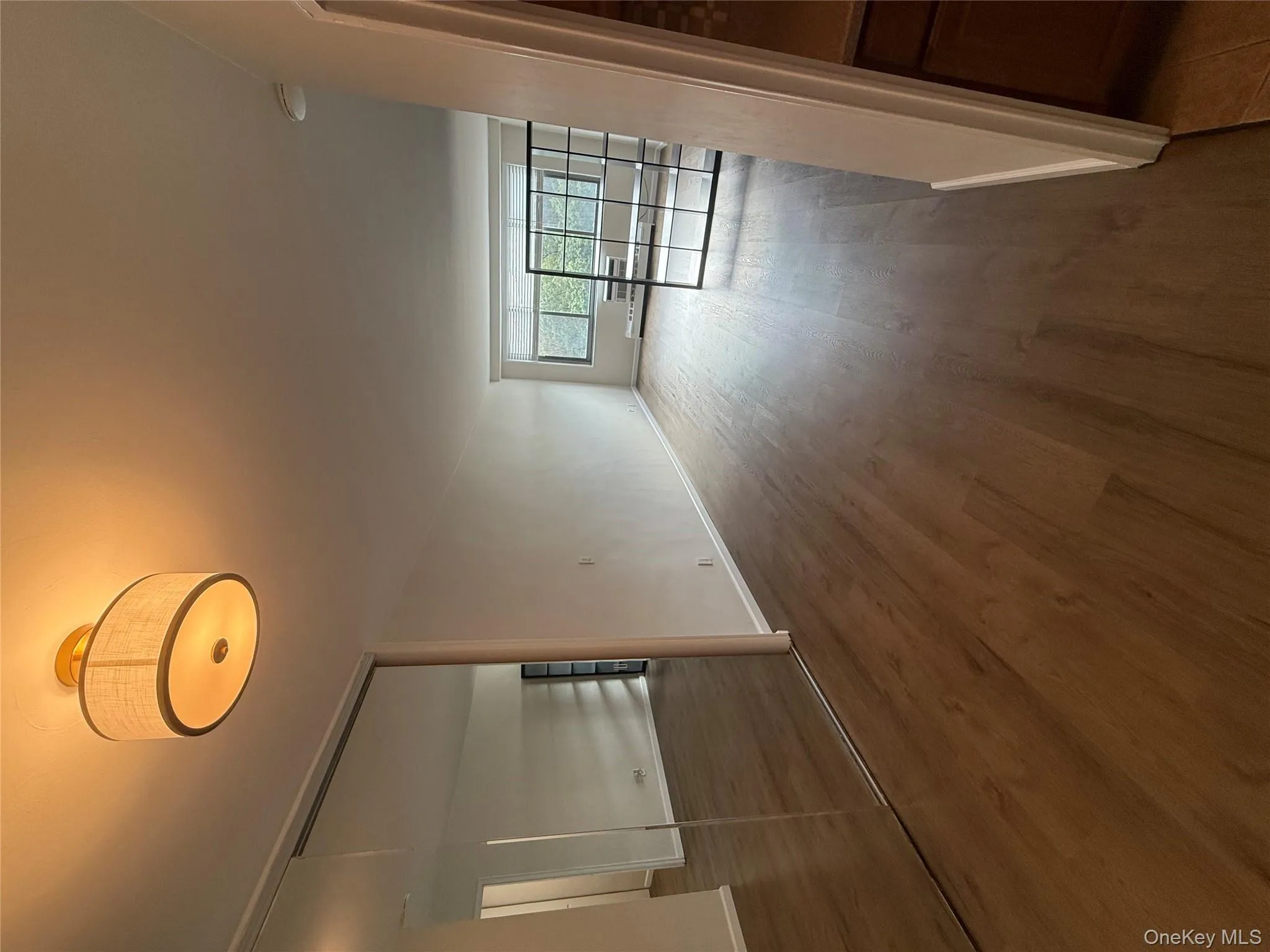 Hall with dark wood-style floors and baseboard heating Hall with dark wood-style floors and baseboard heating