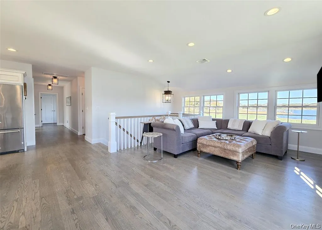 Living room with recessed lighting and light wood-type flooring Living room with recessed lighting and light wood-type flooring