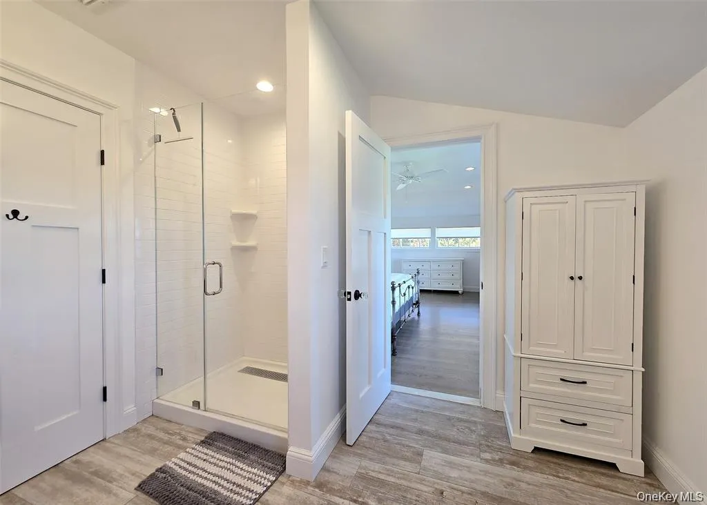 Ensuite bathroom with light wood finished floors, a stall shower, recessed lighting, and ceiling fan Ensuite bathroom with light wood finished floors, a stall shower, recessed lighting, and ceiling fan