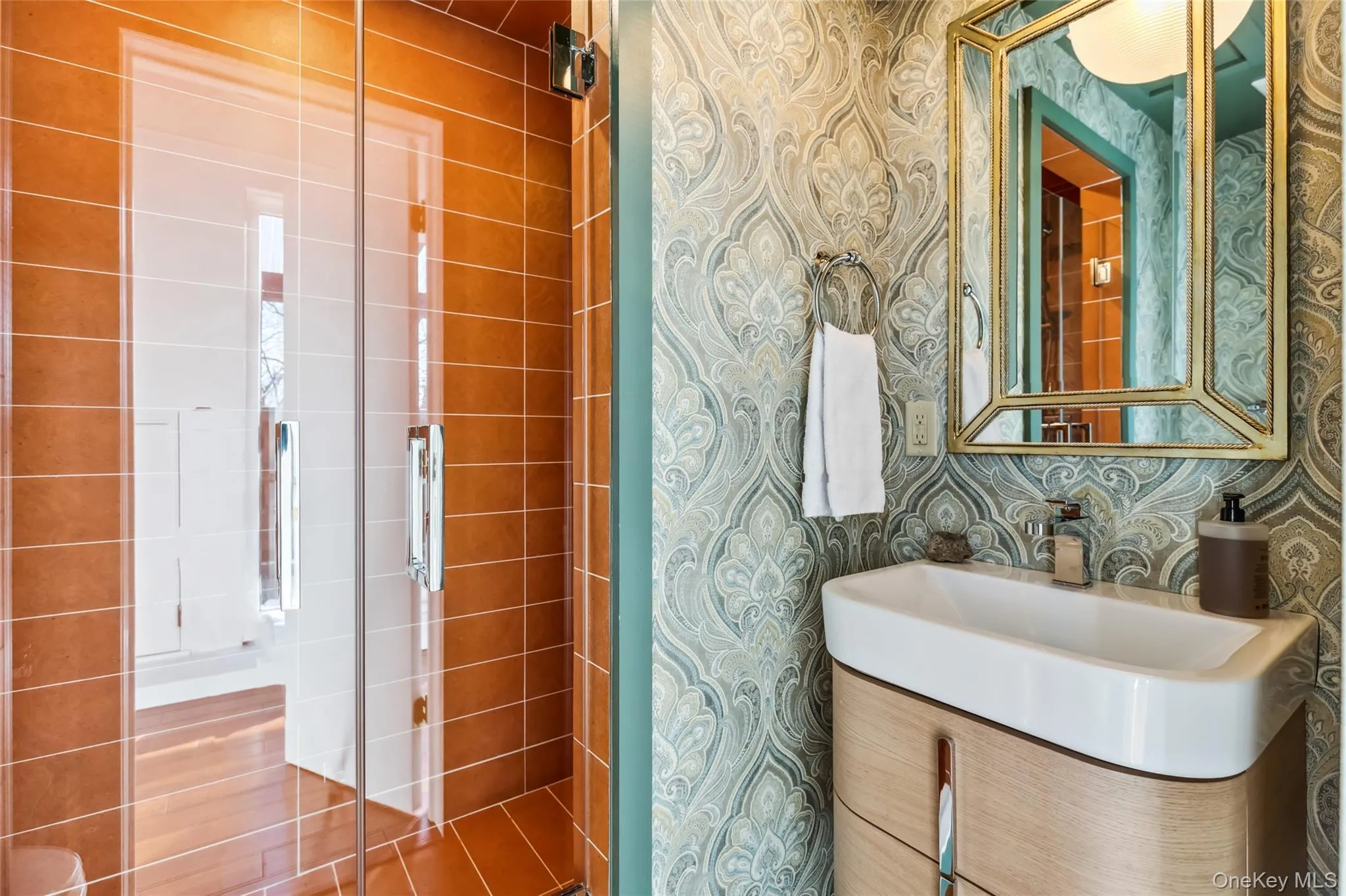 Bathroom featuring vanity and tile walls Bathroom featuring vanity and tile walls