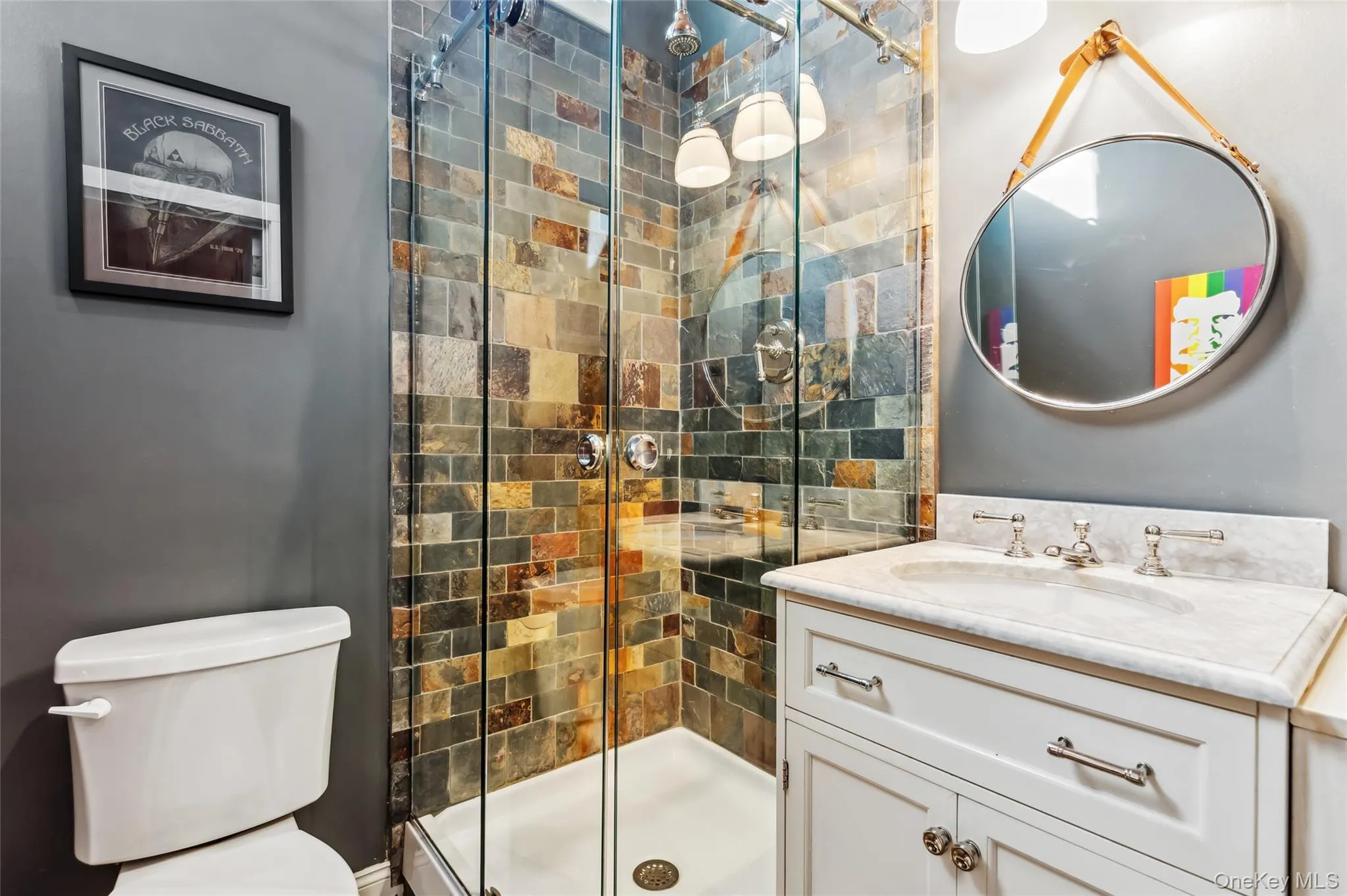 Bathroom with an enclosed shower, vanity, and toilet Bathroom with an enclosed shower, vanity, and toilet