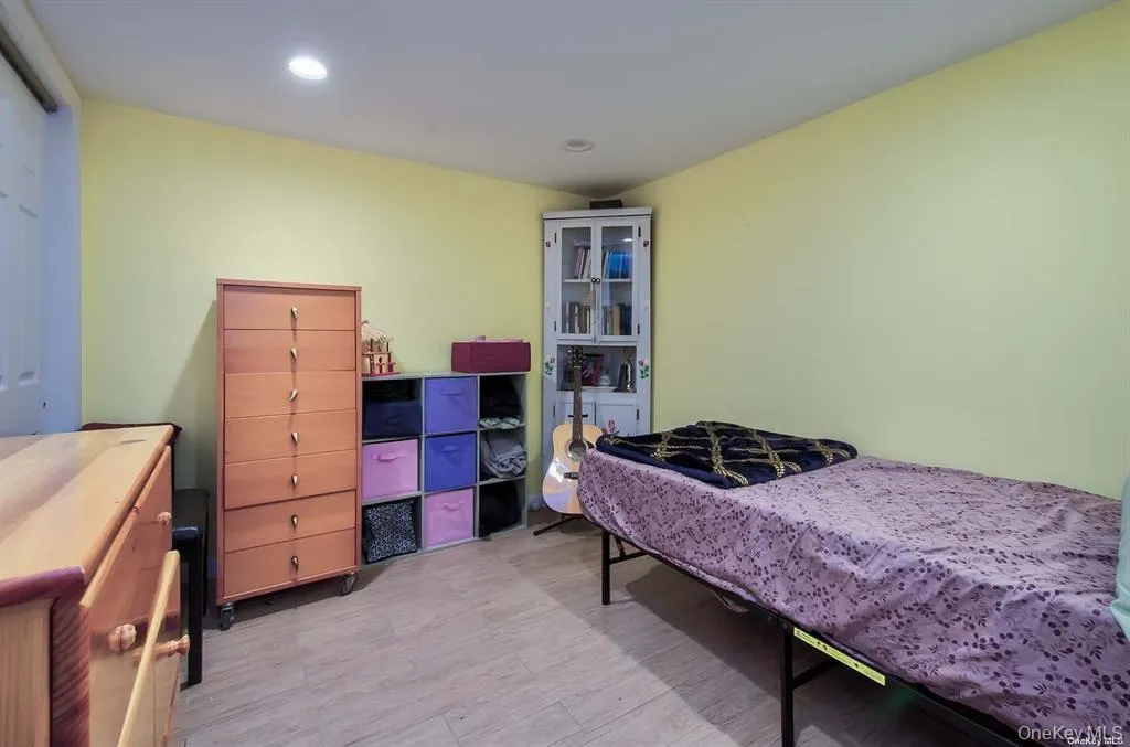 Bedroom featuring light wood-type flooring and recessed lighting Bedroom featuring light wood-type flooring and recessed lighting