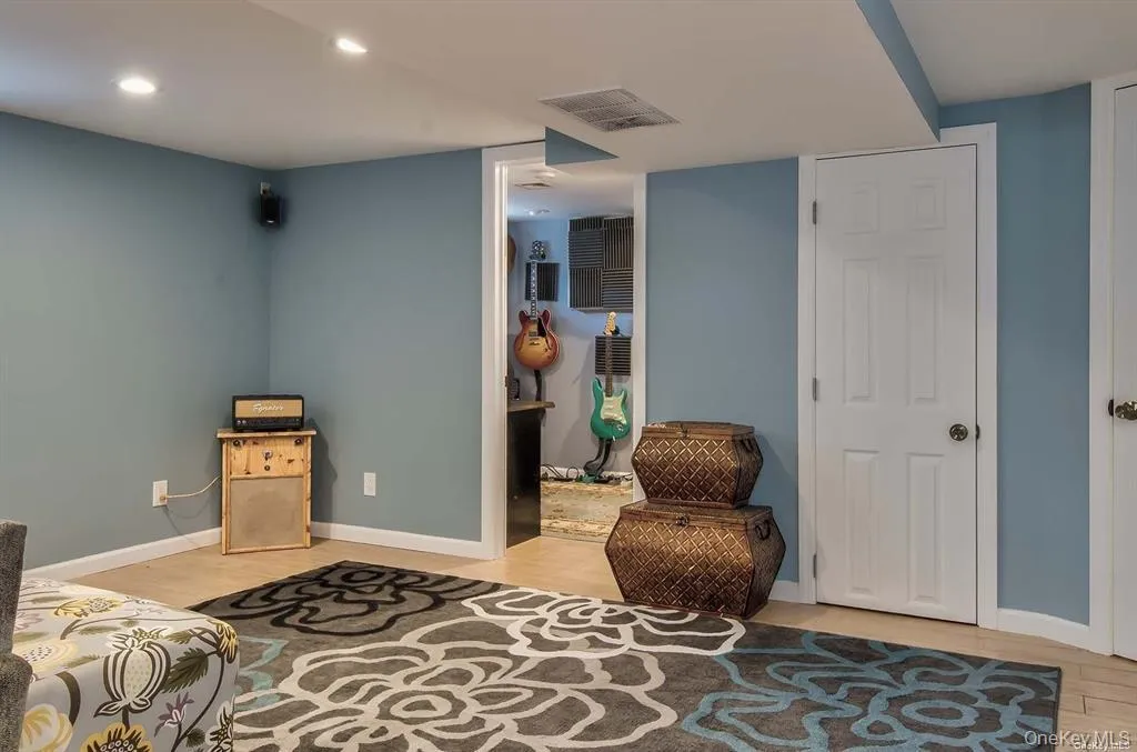 Living area with light wood finished floors and recessed lighting Living area with light wood finished floors and recessed lighting