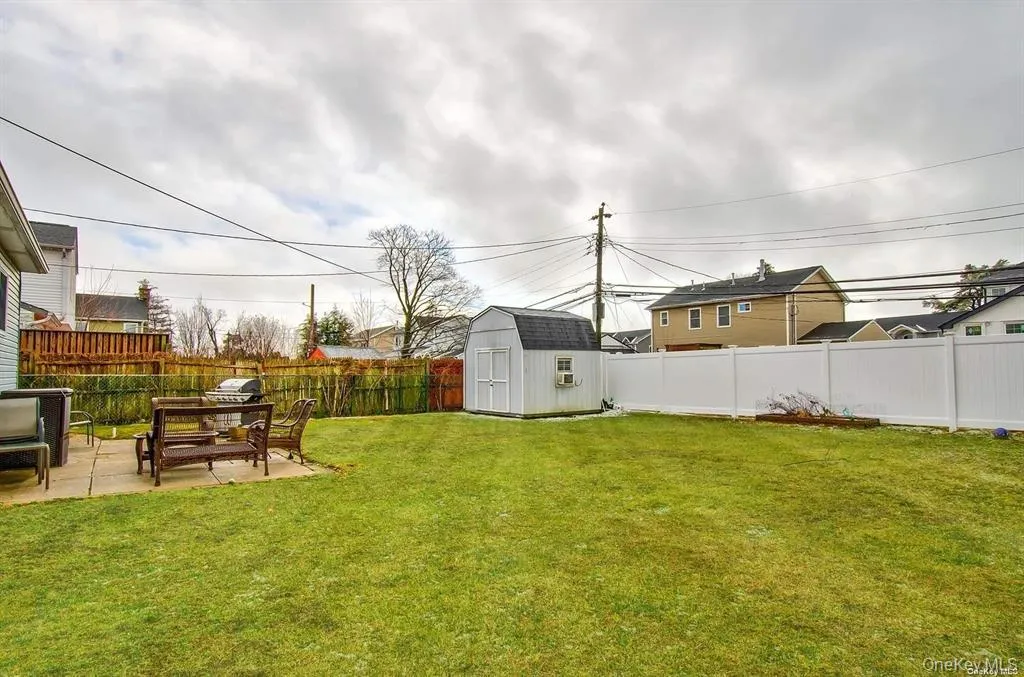 Fenced backyard featuring a storage shed and a patio Fenced backyard featuring a storage shed and a patio