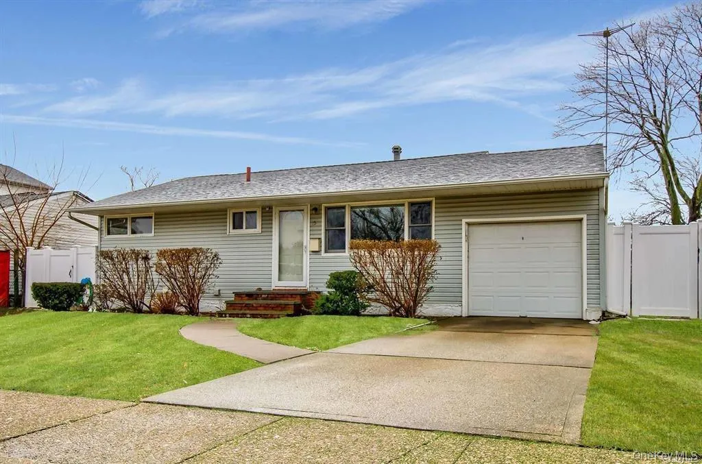 Ranch-style home with a garage, concrete driveway, and a shingled roof Ranch-style home with a garage, concrete driveway, and a shingled roof