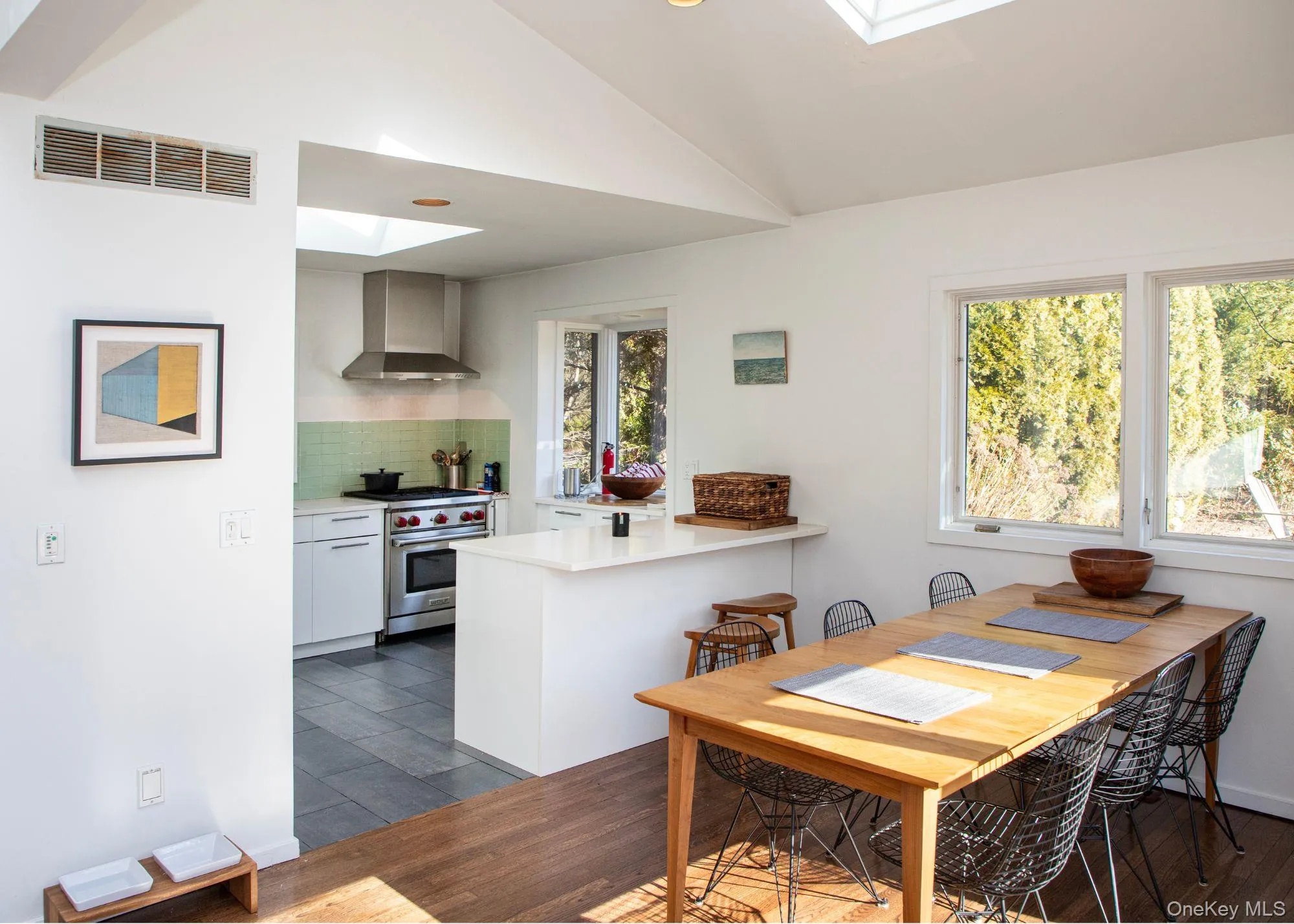 Dining room featuring lofted ceiling with sliders to deck Dining room featuring lofted ceiling with sliders to deck