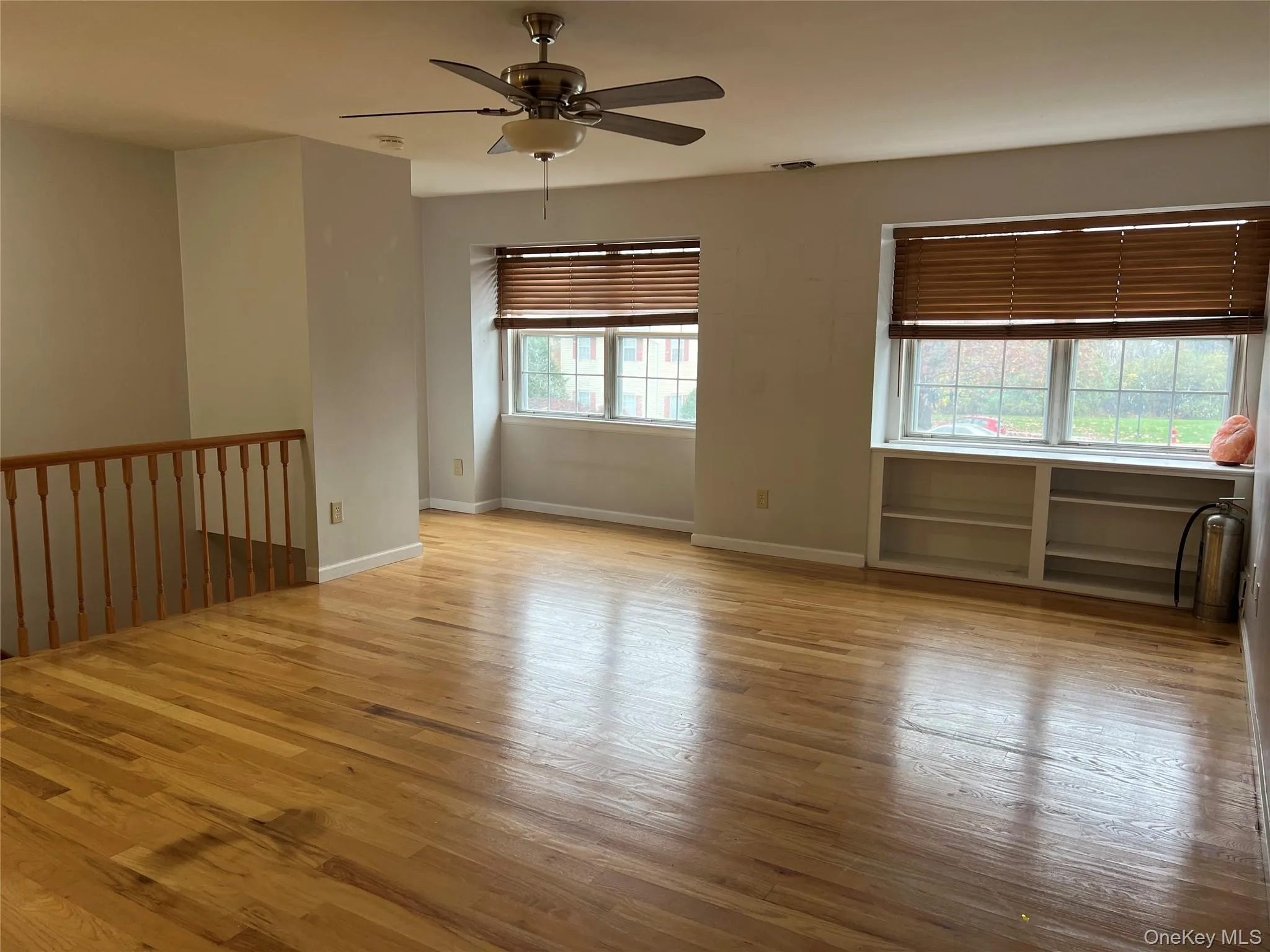 Empty room featuring light wood finished floors and ceiling fan Empty room featuring light wood finished floors and ceiling fan