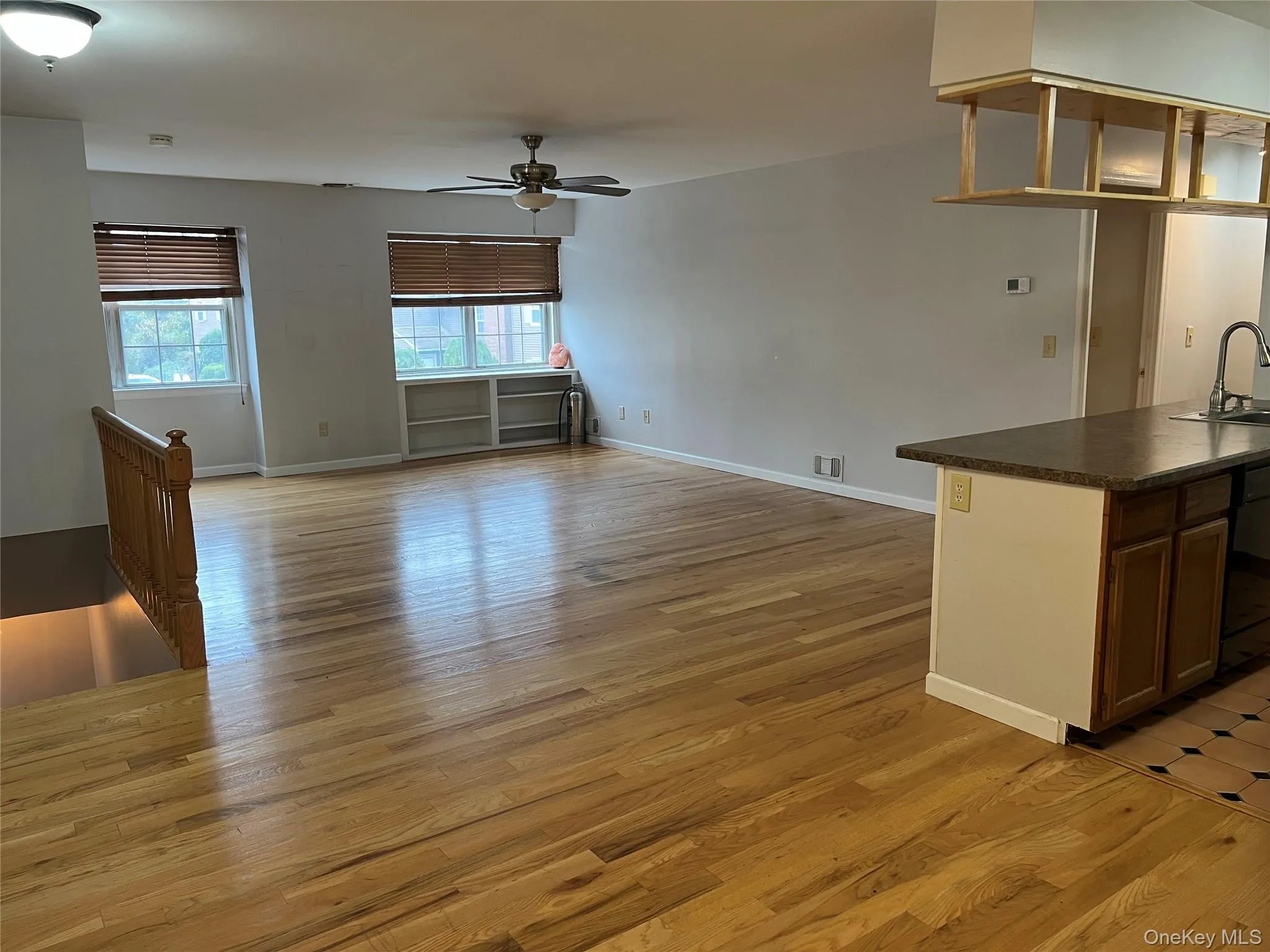 Unfurnished living room with light wood-style floors and ceiling fan Unfurnished living room with light wood-style floors and ceiling fan