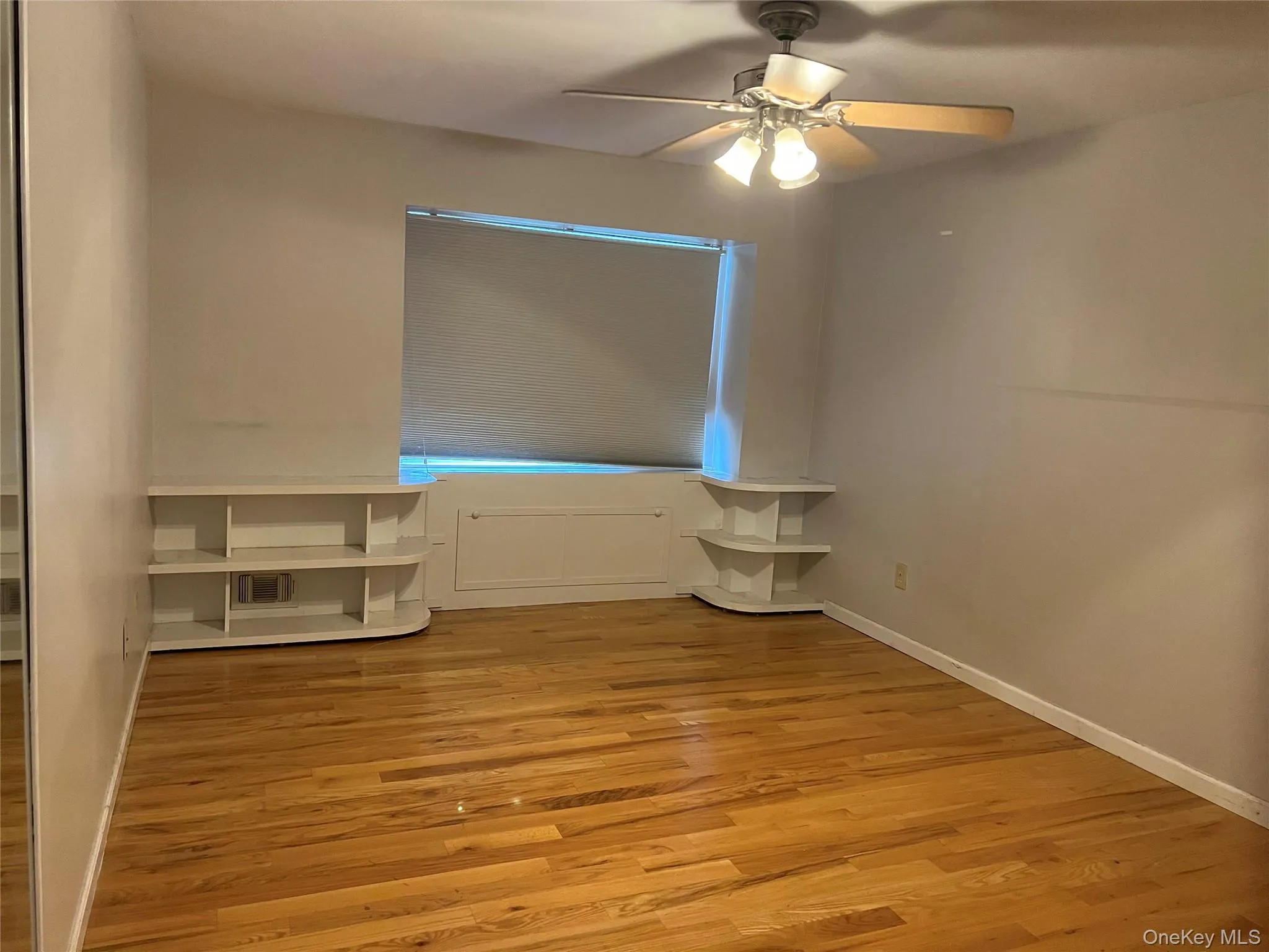 Unfurnished bedroom with light wood finished floors and ceiling fan Unfurnished bedroom with light wood finished floors and ceiling fan