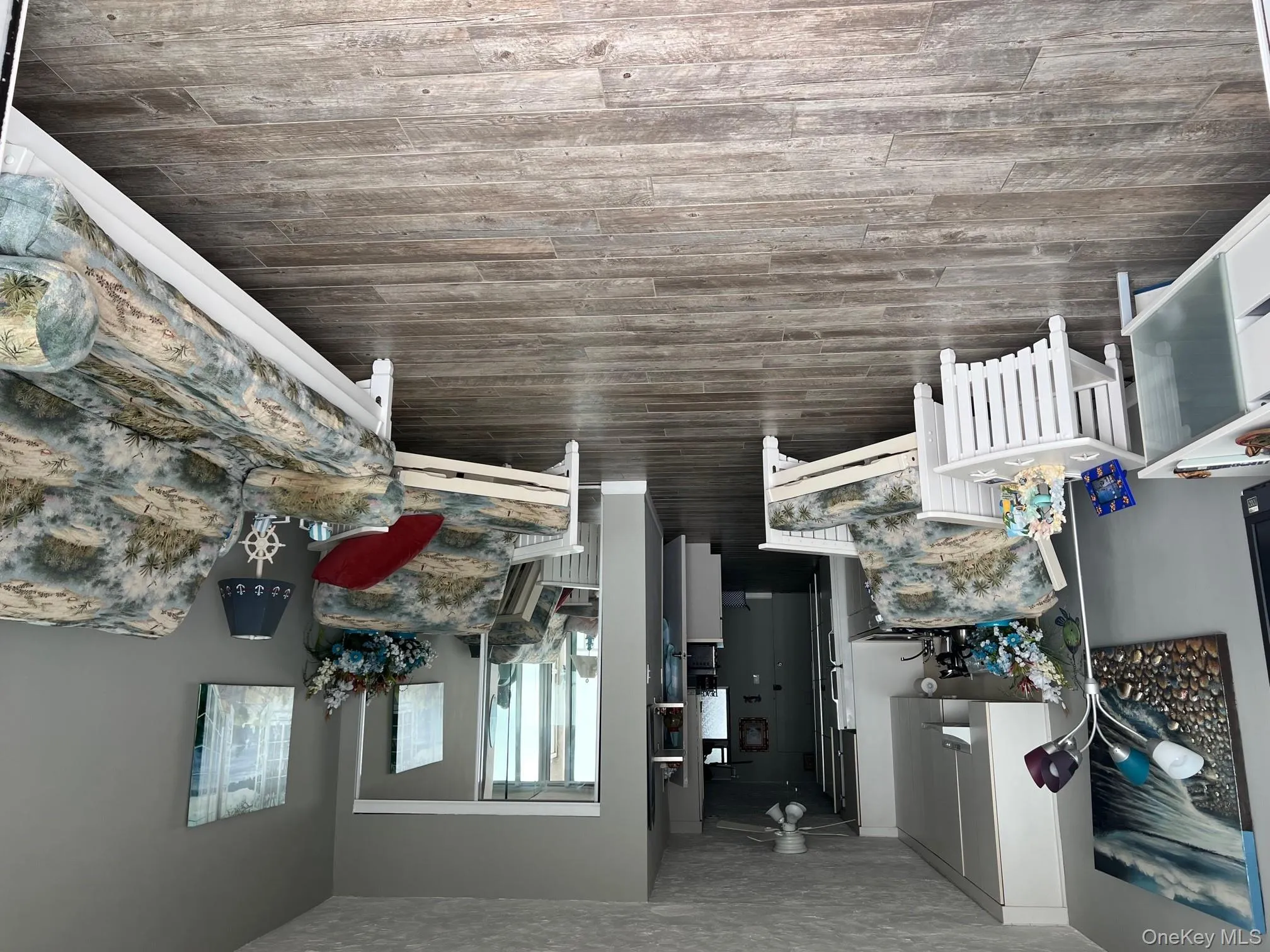 Living room featuring light wood-style floors, a textured ceiling, and ceiling fan Living room featuring light wood-style floors, a textured ceiling, and ceiling fan