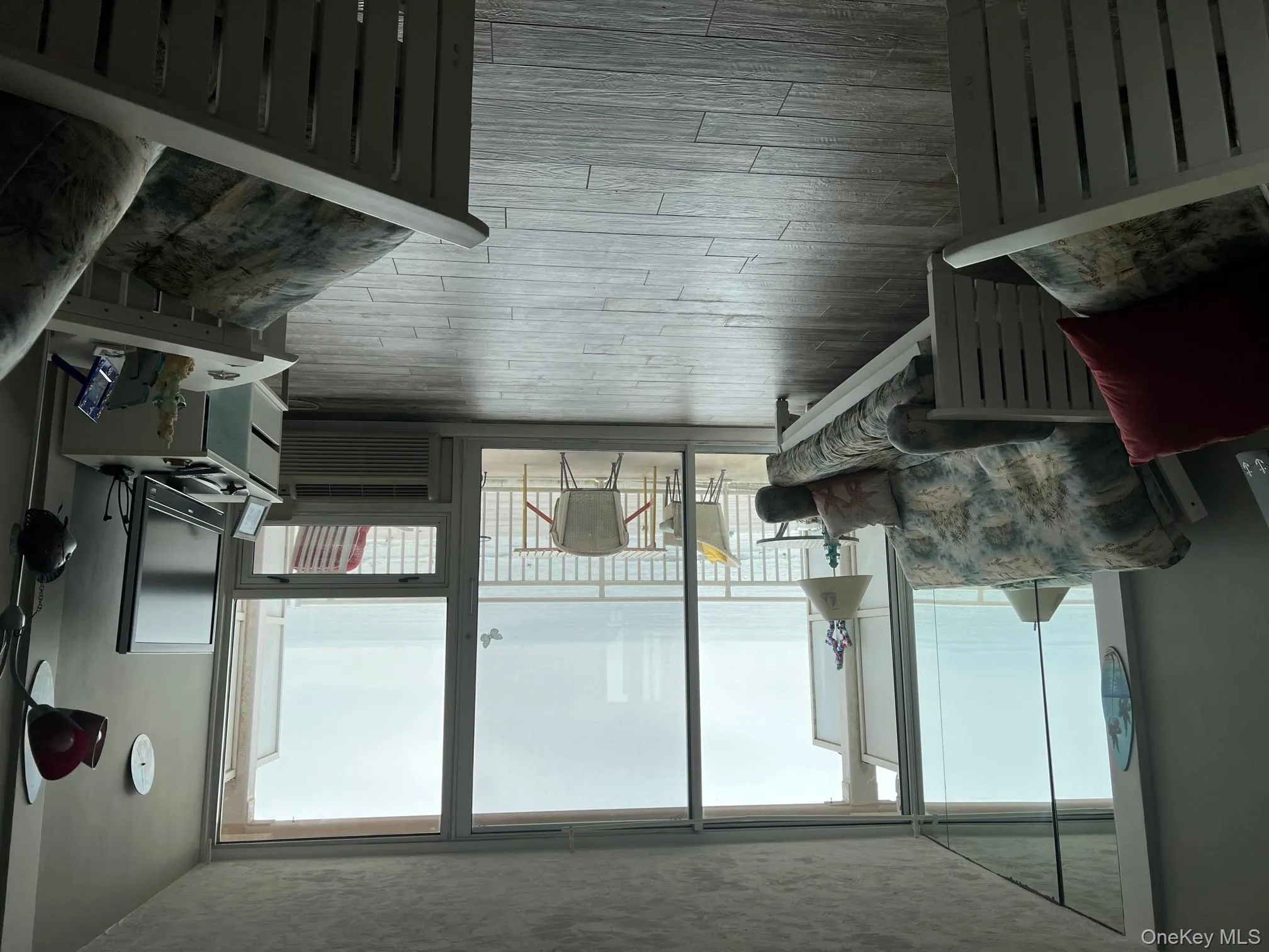 Living room featuring light wood-style flooring and a wall of windows Living room featuring light wood-style flooring and a wall of windows