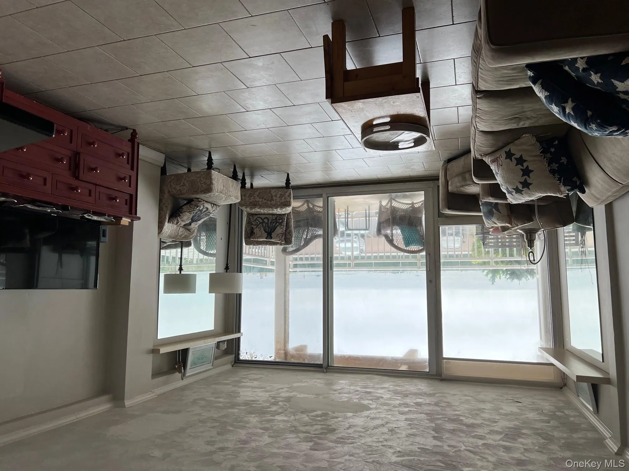 Living area with expansive windows, crown molding, and light tile patterned flooring Living area with expansive windows, crown molding, and light tile patterned flooring