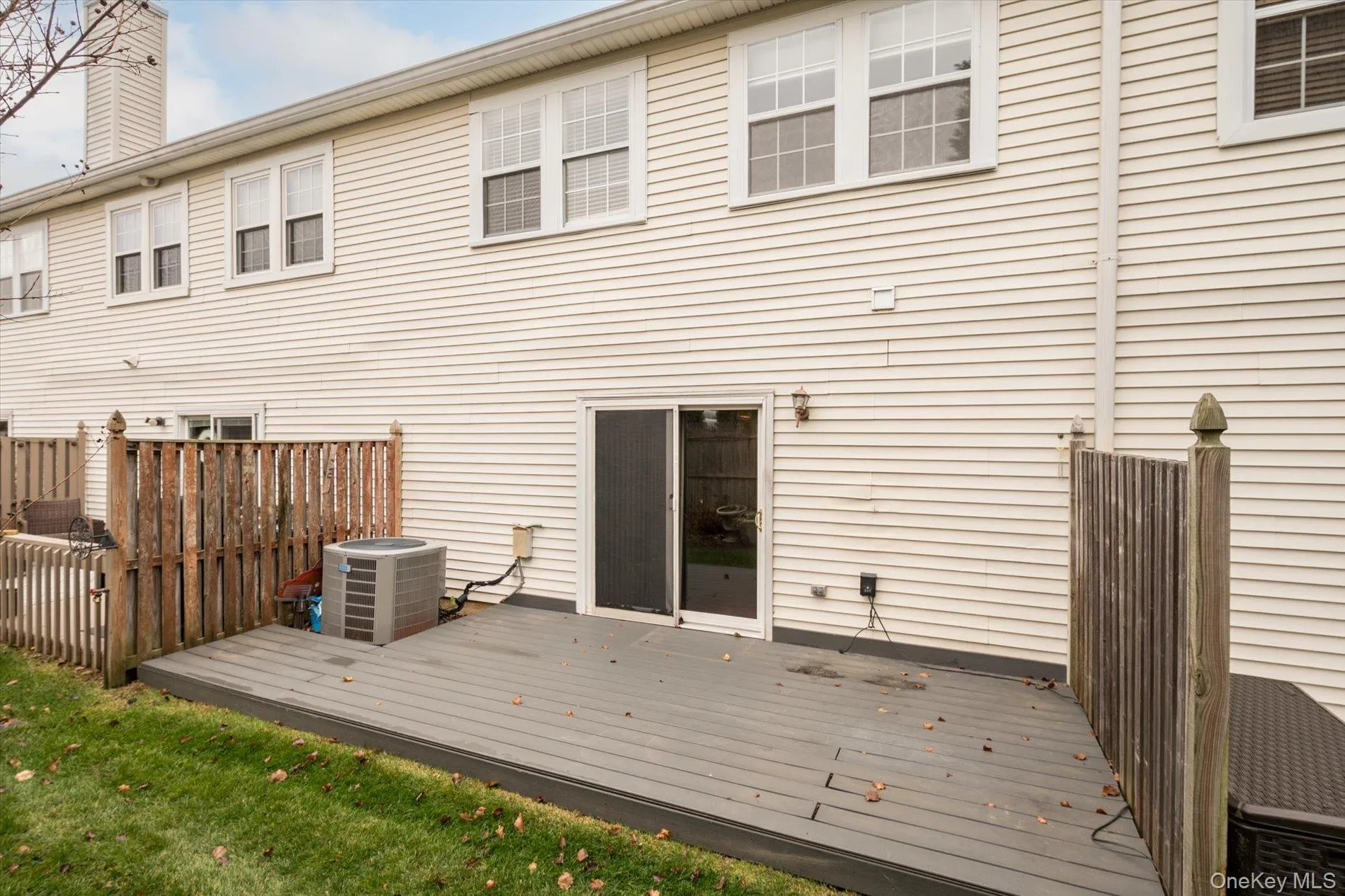 Rear view of house with a deck and a chimney Rear view of house with a deck and a chimney