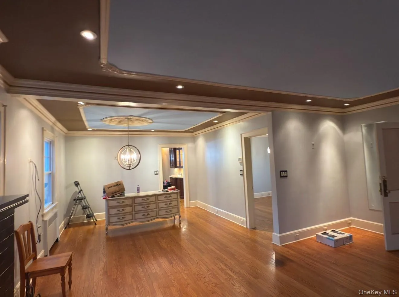 Dining with detailed molding, hardwood flooring and natural light Dining with detailed molding, hardwood flooring and natural light