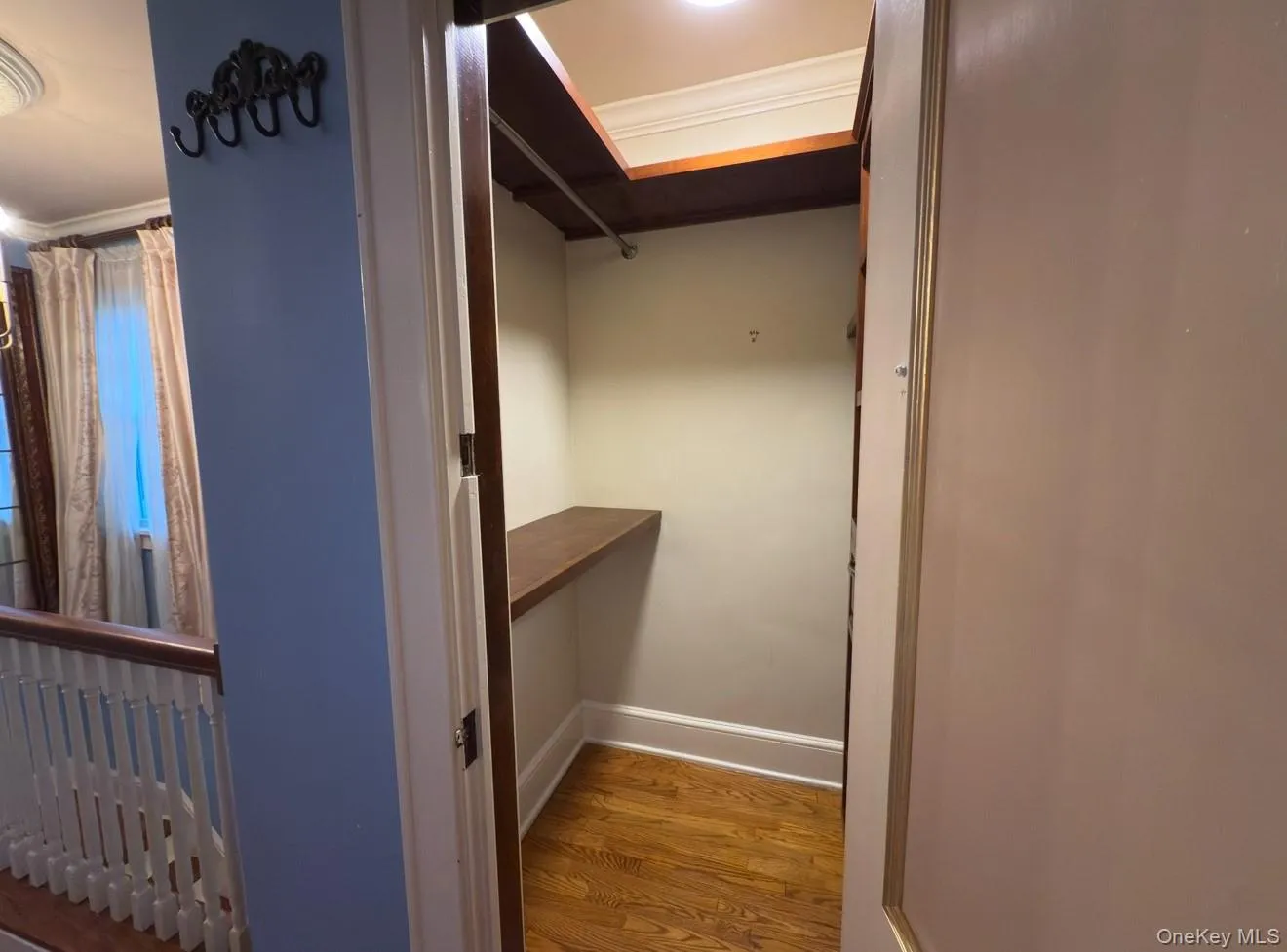 Spacious closet featuring light wood-type flooring Spacious closet featuring light wood-type flooring
