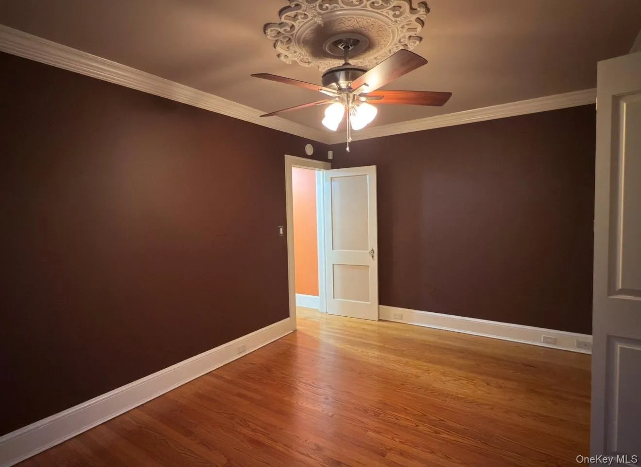 Bedroom 3 with hardwood flooring, ceiling fan and crown molding Bedroom 3 with hardwood flooring, ceiling fan and crown molding