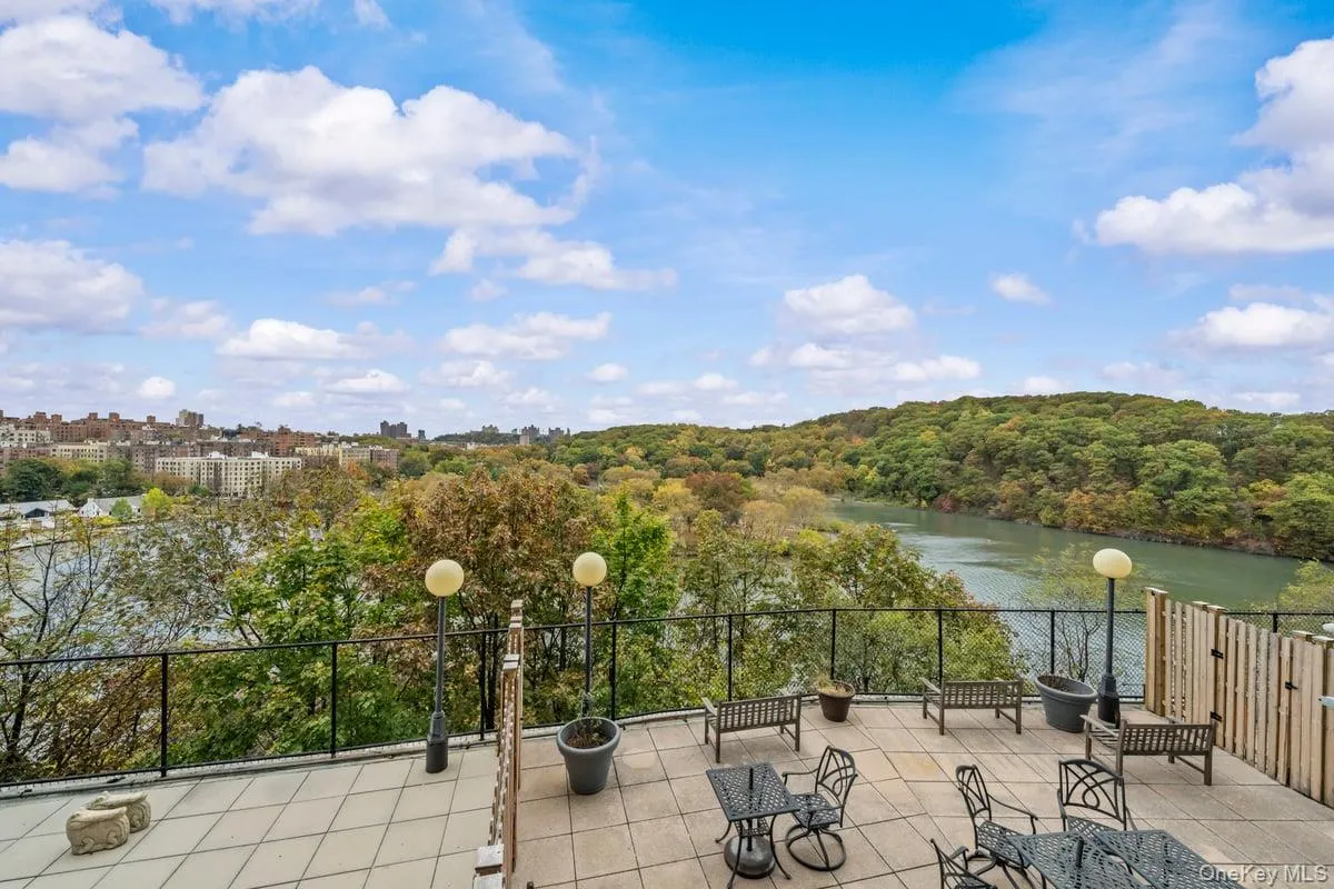 View of patio with a wooded view and a water view View of patio with a wooded view and a water view