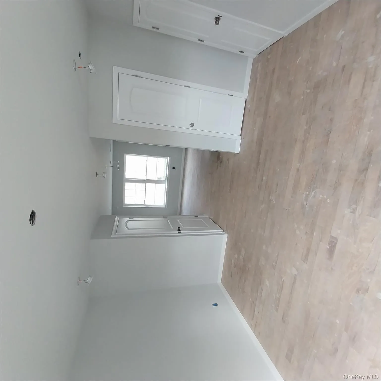 Spare room with baseboards and light wood-style flooring Spare room with baseboards and light wood-style flooring