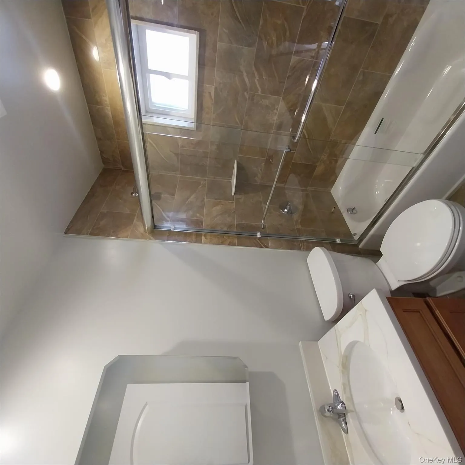 Full bath with shower / bath combination with glass door, vanity, and recessed lighting Full bath with shower / bath combination with glass door, vanity, and recessed lighting